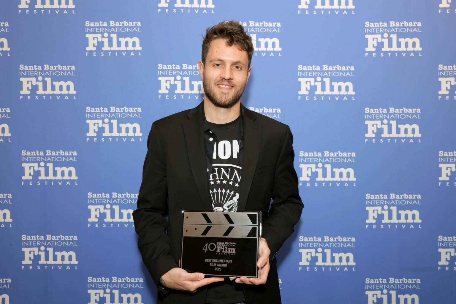 SANTA BARBARA, CALIFORNIA - FEBRUARY 15: Nathaniel Lezra poses with the Best Documentary Award for "Roads of Fire" at the Awards Breakfast during the 40th Santa Barbara International Film Festival at El Encanto on February 15, 2025 in Santa Barbara, California. (Photo by Rebecca Sapp/Getty Images for Santa Barbara International Film Festival)
