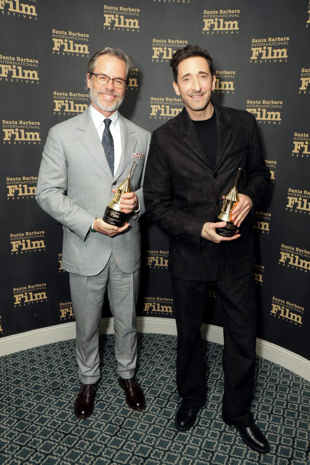 SANTA BARBARA, CALIFORNIA - FEBRUARY 13: (L-R) Honorees Guy Pearce and Adrien Brody pose with the Cinema Vanguard Award during the 40th Santa Barbara International Film Festival at The Arlington Theatre on February 13, 2025 in Santa Barbara, California. (Photo by Rebecca Sapp/Getty Images for Santa Barbara International Film Festival)
