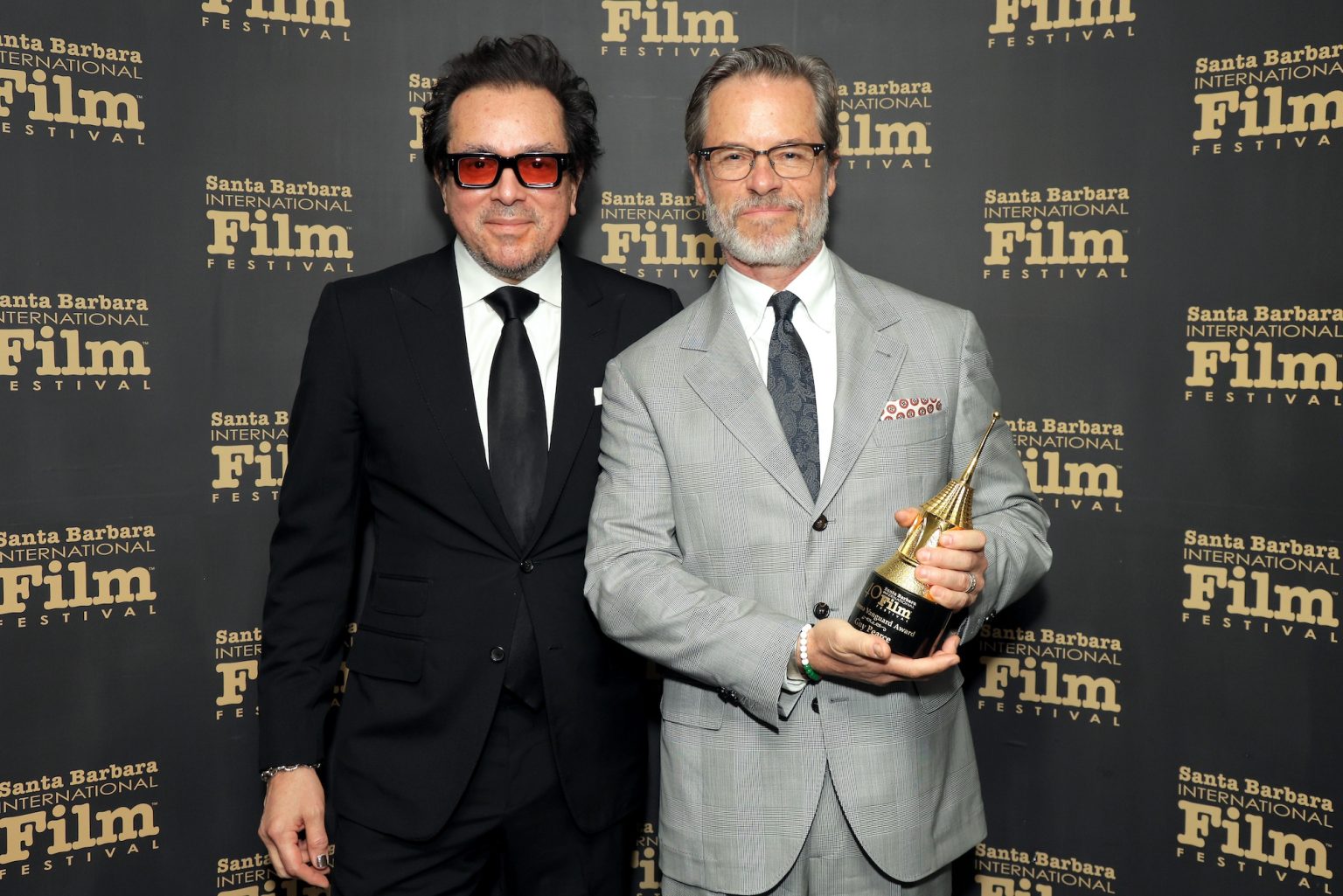 SANTA BARBARA, CALIFORNIA - FEBRUARY 13: (L-R) SBIFF Executive Director Roger Durling and honoree Guy Pearce pose with the Cinema Vanguard Award during the 40th Santa Barbara International Film Festival at The Arlington Theatre on February 13, 2025 in Santa Barbara, California. (Photo by Rebecca Sapp/Getty Images for Santa Barbara International Film Festival)