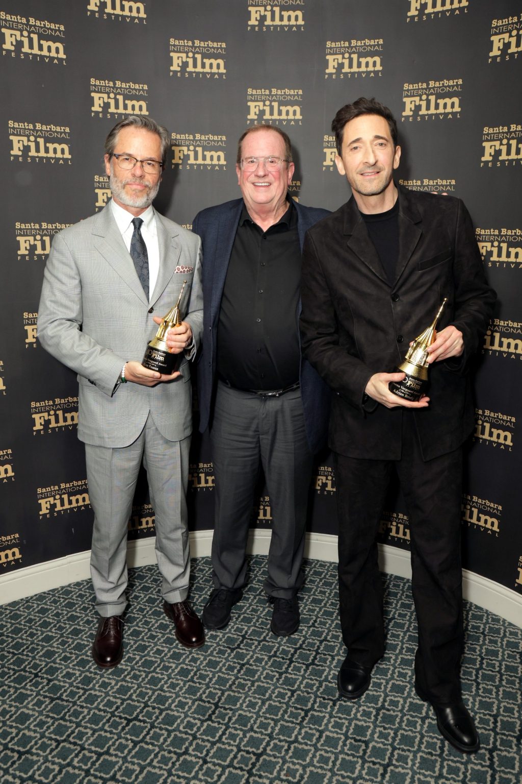 SANTA BARBARA, CALIFORNIA - FEBRUARY 13: (L-R) Honoree Guy Pearce, Pete Hammond, and honoree Adrien Brody pose with the Cinema Vanguard Award during the 40th Santa Barbara International Film Festival at The Arlington Theatre on February 13, 2025 in Santa Barbara, California. (Photo by Rebecca Sapp/Getty Images for Santa Barbara International Film Festival)