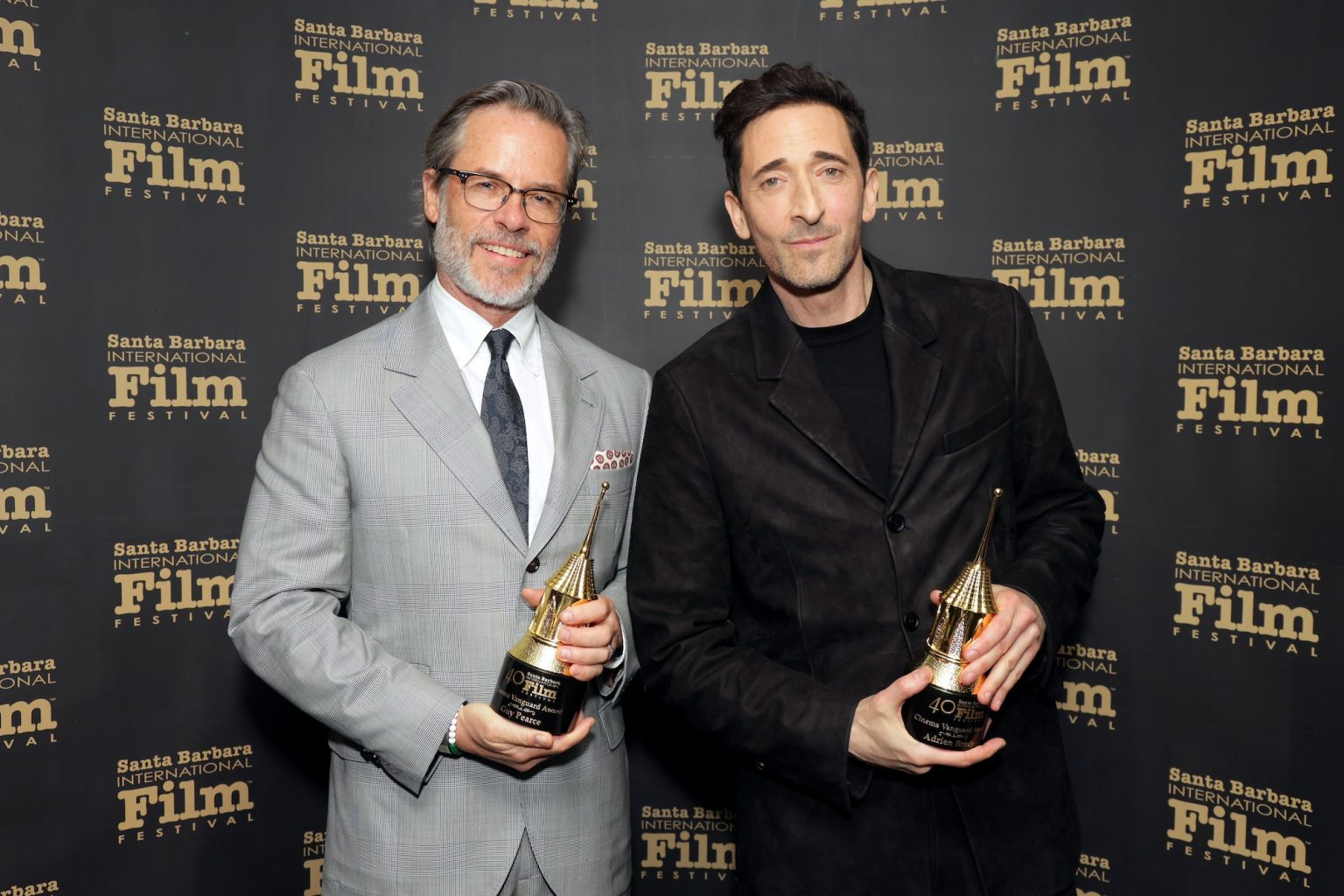 SANTA BARBARA, CALIFORNIA - FEBRUARY 13: (L-R) Honorees Guy Pearce and Adrien Brody pose with the Cinema Vanguard Award during the 40th Santa Barbara International Film Festival at The Arlington Theatre on February 13, 2025 in Santa Barbara, California. (Photo by Rebecca Sapp/Getty Images for Santa Barbara International Film Festival)
