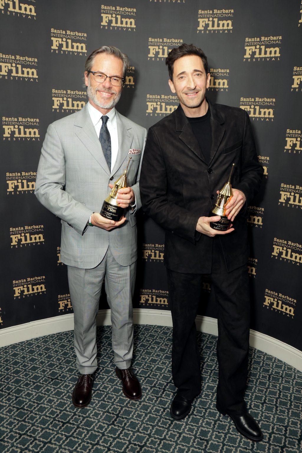 SANTA BARBARA, CALIFORNIA - FEBRUARY 13: (L-R) Honorees Guy Pearce and Adrien Brody pose with the Cinema Vanguard Award during the 40th Santa Barbara International Film Festival at The Arlington Theatre on February 13, 2025 in Santa Barbara, California. (Photo by Rebecca Sapp/Getty Images for Santa Barbara International Film Festival)