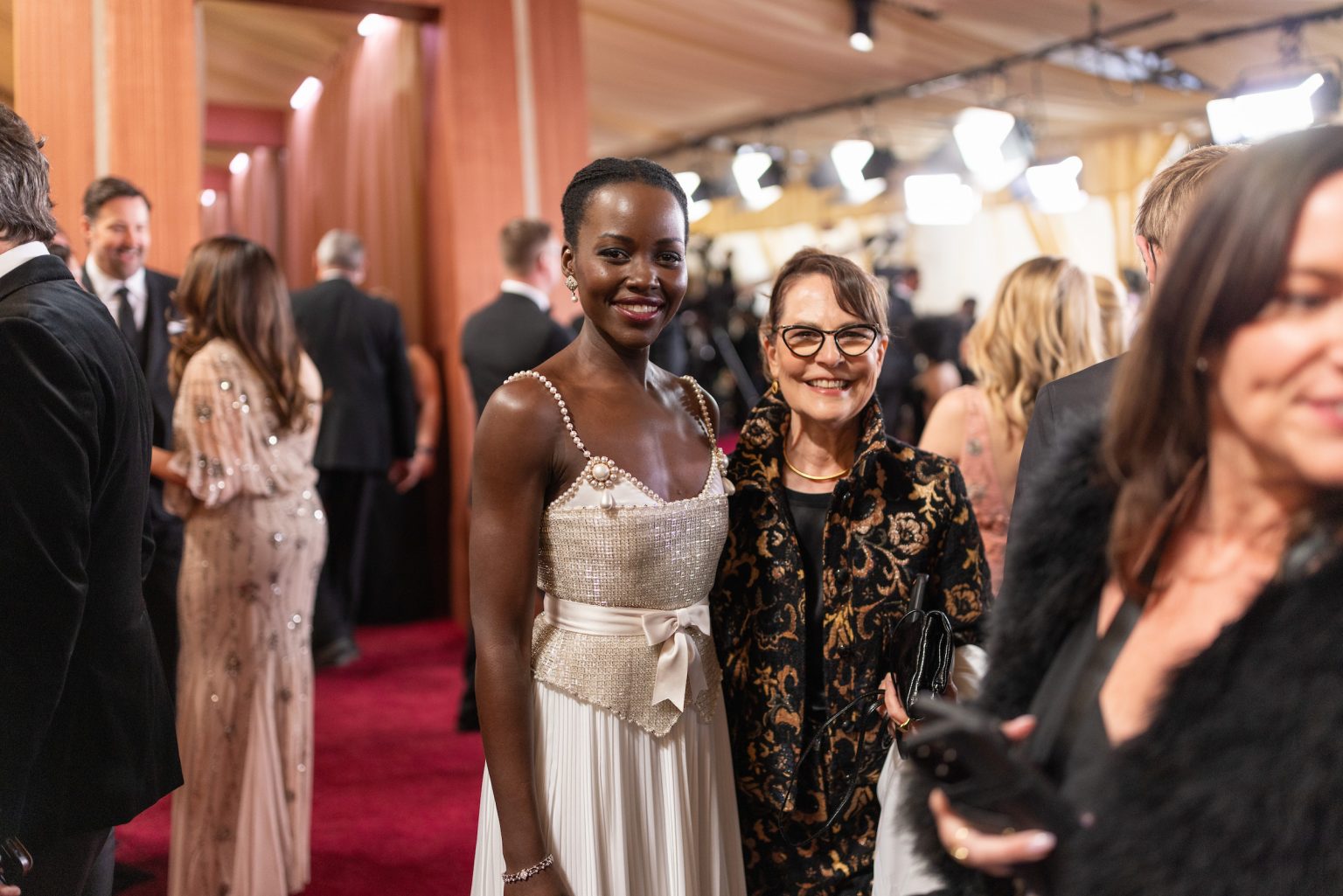 Lupita Nyong’o and guest arrive on the red carpet of the 97th Oscars® at the Dolby® Theatre at Ovation Hollywood on Sunday, March 2, 2025.