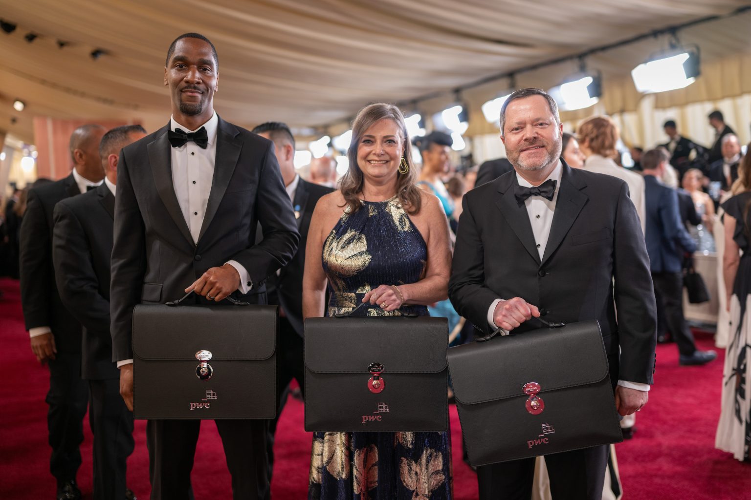 Representatives of PricewaterhouseCoopers (PwC) arrive on the red carpet of the 97th Oscars® at the Dolby® Theatre at Ovation Hollywood on Sunday, March 2, 2025.