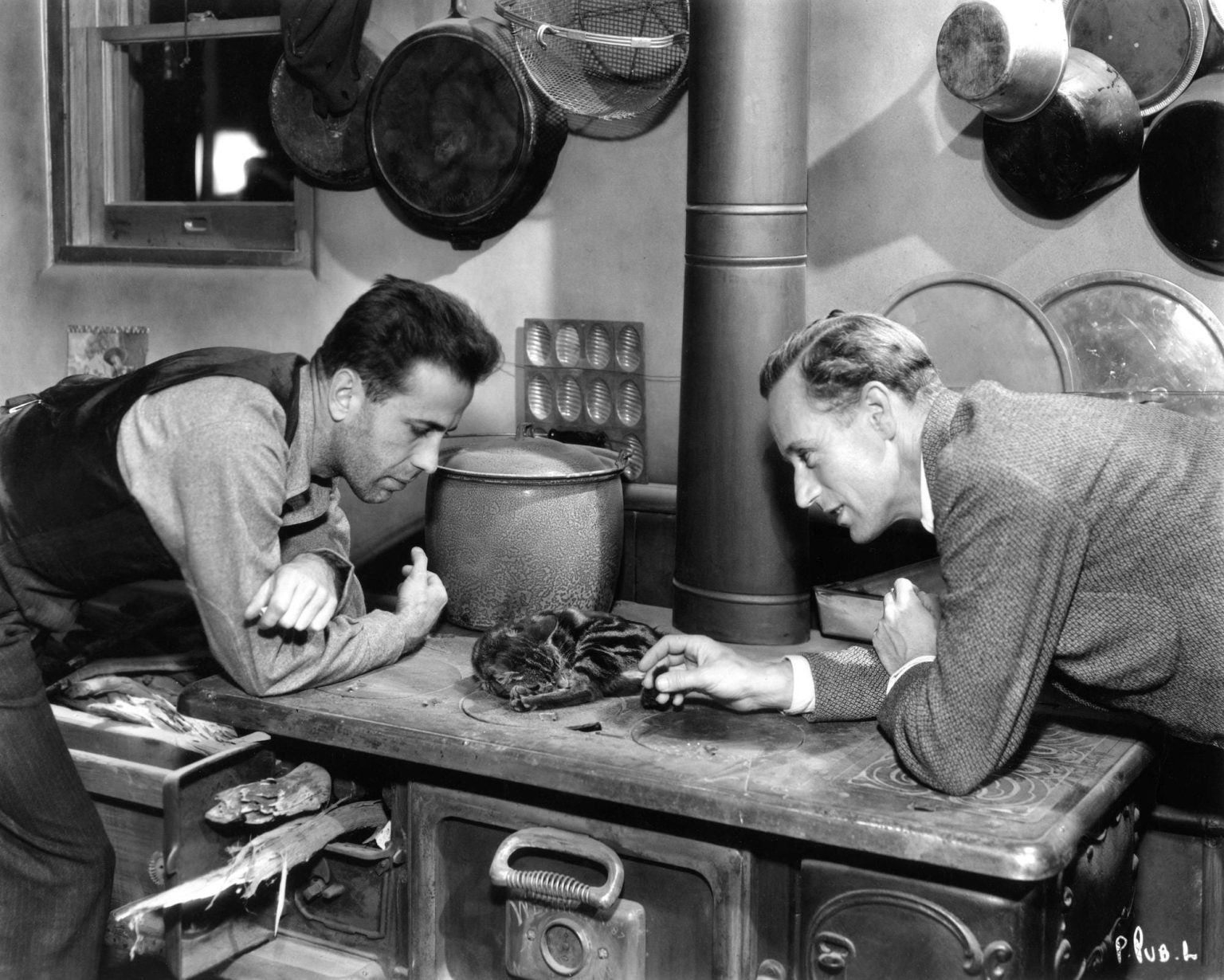 HUMPHREY BOGART and LESLIE HOWARD on set candid with a Cat during a break in filming of THE PETRIFIED FOREST 1936 director ARCHIE MAYO play Robert E. Sherwood screenplay Charles Kenyon and Delmer Daves Warner Bros.