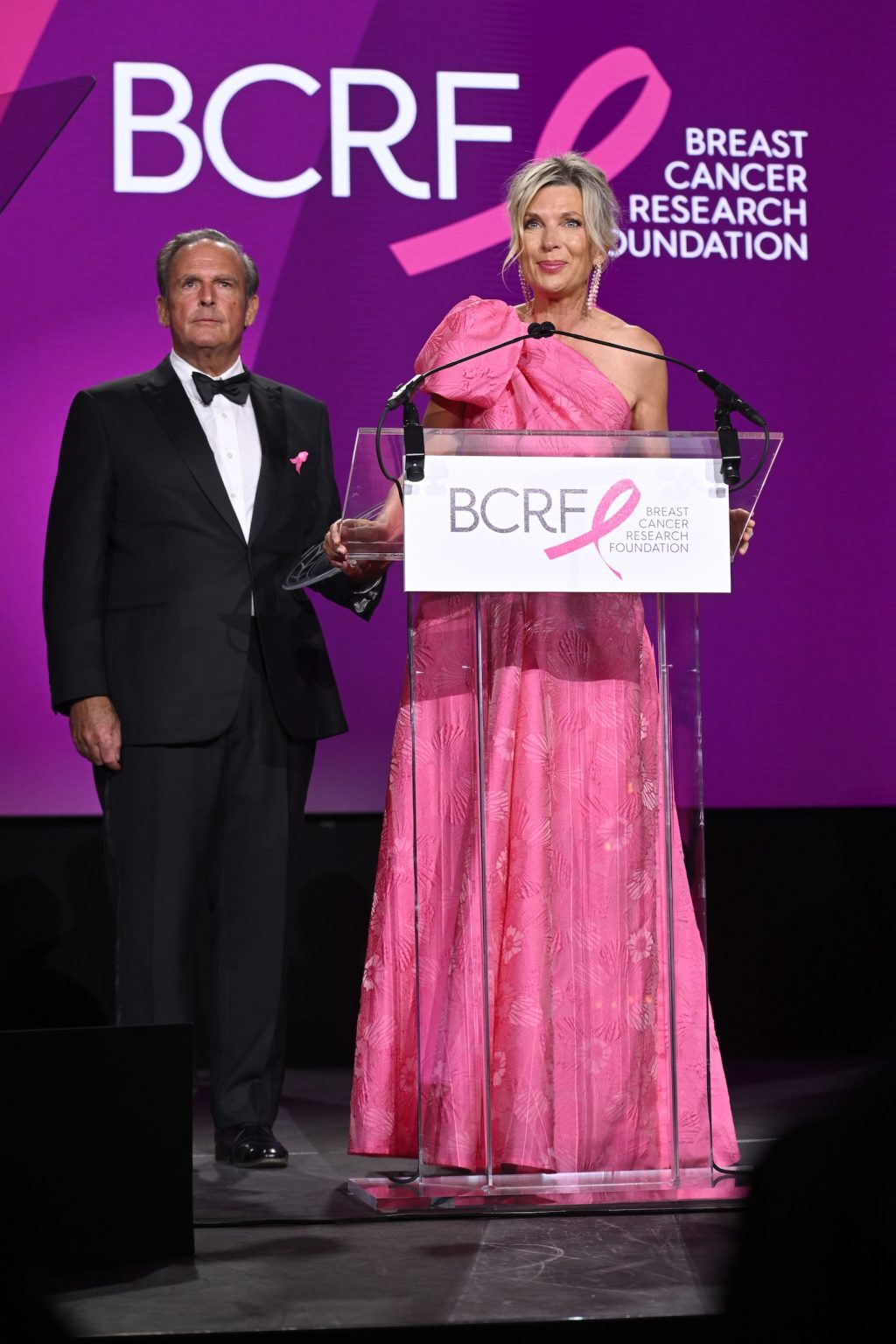 NEW YORK, NEW YORK - MAY 13: (L-R) Peter Cancro and Tatiana Cancro speak onstage during the Breast Cancer Research Foundation Hot Pink Party 2025 at The Glasshouse on May 13, 2025 in New York City. (Photo by Noam Galai/Getty Images for Breast Cancer Research Foundation)
