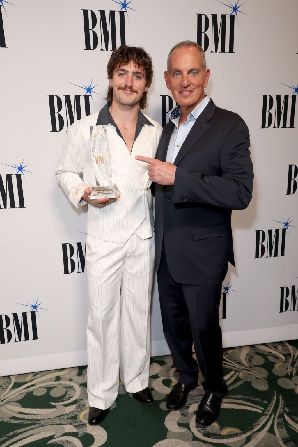 BEVERLY HILLS, CALIFORNIA - MAY 13: (L-R) BMI Champion Award Honoree Benson Boone and Mike O'Neill, President & Chief Executive Officer, BMI, attend the 2025 BMI Pop Awards at Beverly Wilshire, A Four Seasons Hotel on May 13, 2025 in Beverly Hills, California. (Photo by JC Olivera/Getty Images for BMI)