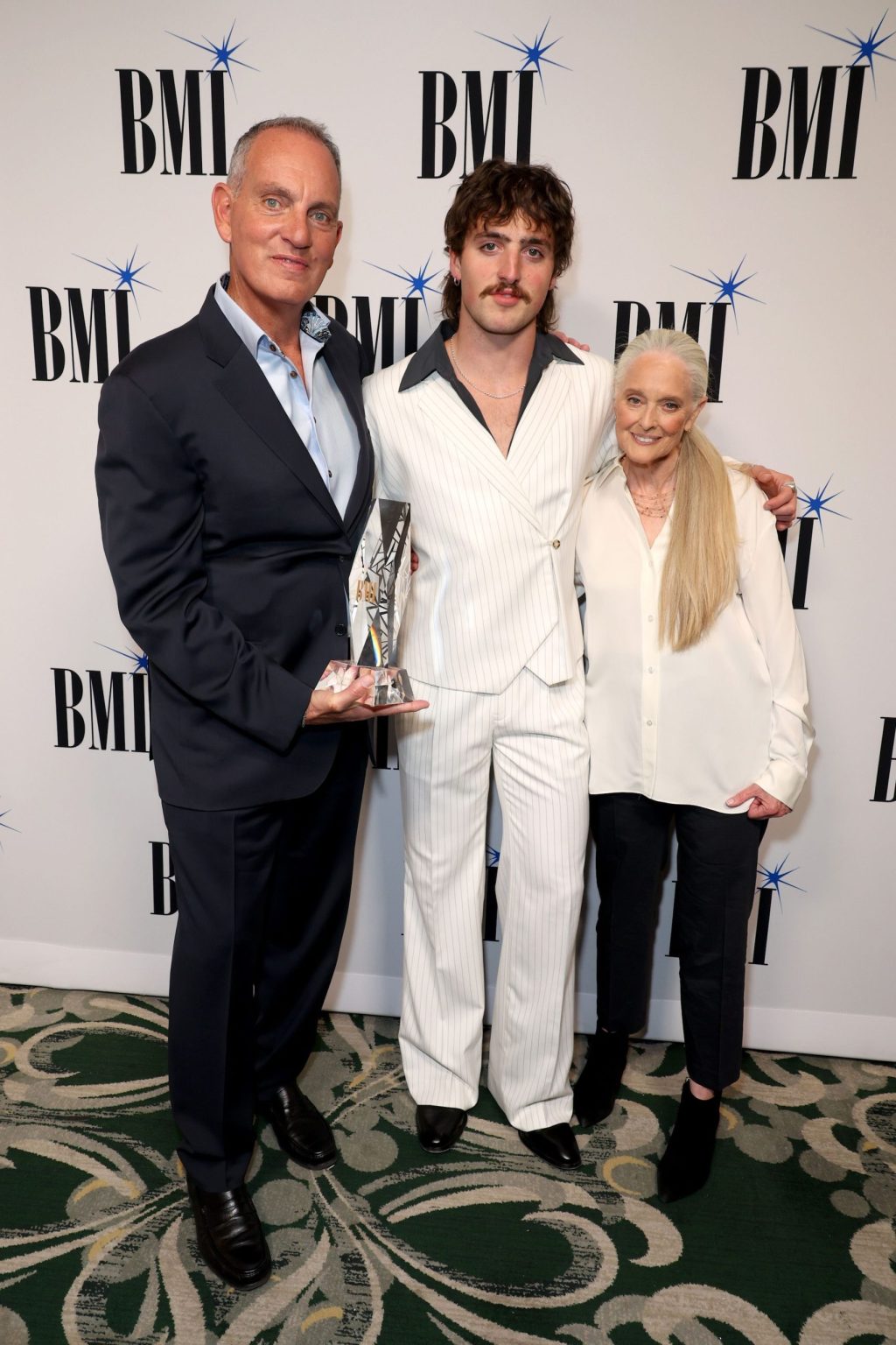 BEVERLY HILLS, CALIFORNIA - MAY 13: (L-R) Mike O'Neill, President & Chief Executive Officer, BMI, honoree Benson Boone, recipient of the BMI Champion Award, and Barbara Cane, Vice President, Worldwide Creative, BMI, and Advisor to Executive Vice President, Chief Revenue & Creative Officer, BMI, attend the 2025 BMI Pop Awards at Beverly Wilshire, A Four Seasons Hotel on May 13, 2025 in Beverly Hills, California. (Photo by JC Olivera/Getty Images for BMI)