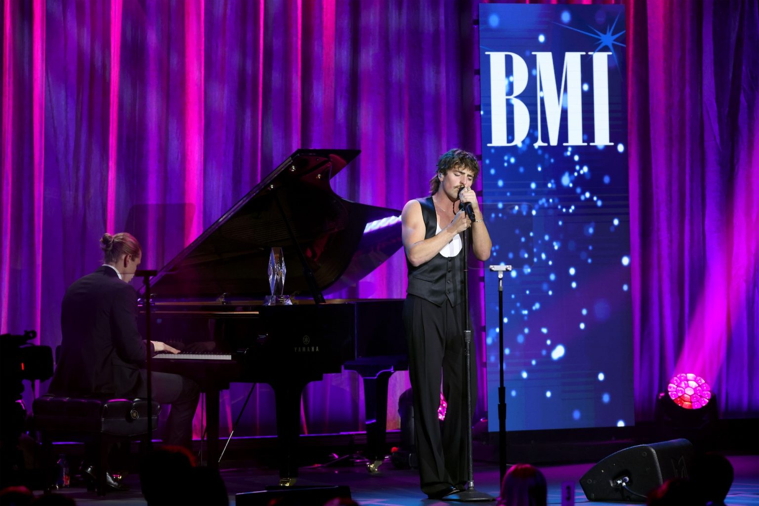 BEVERLY HILLS, CALIFORNIA - MAY 13: Benson Boone (R) performs onstage during the 2025 BMI Pop Awards at Beverly Wilshire, A Four Seasons Hotel, on May 13, 2025 in Beverly Hills, California. (Photo by JC Olivera/Getty Images for BMI)