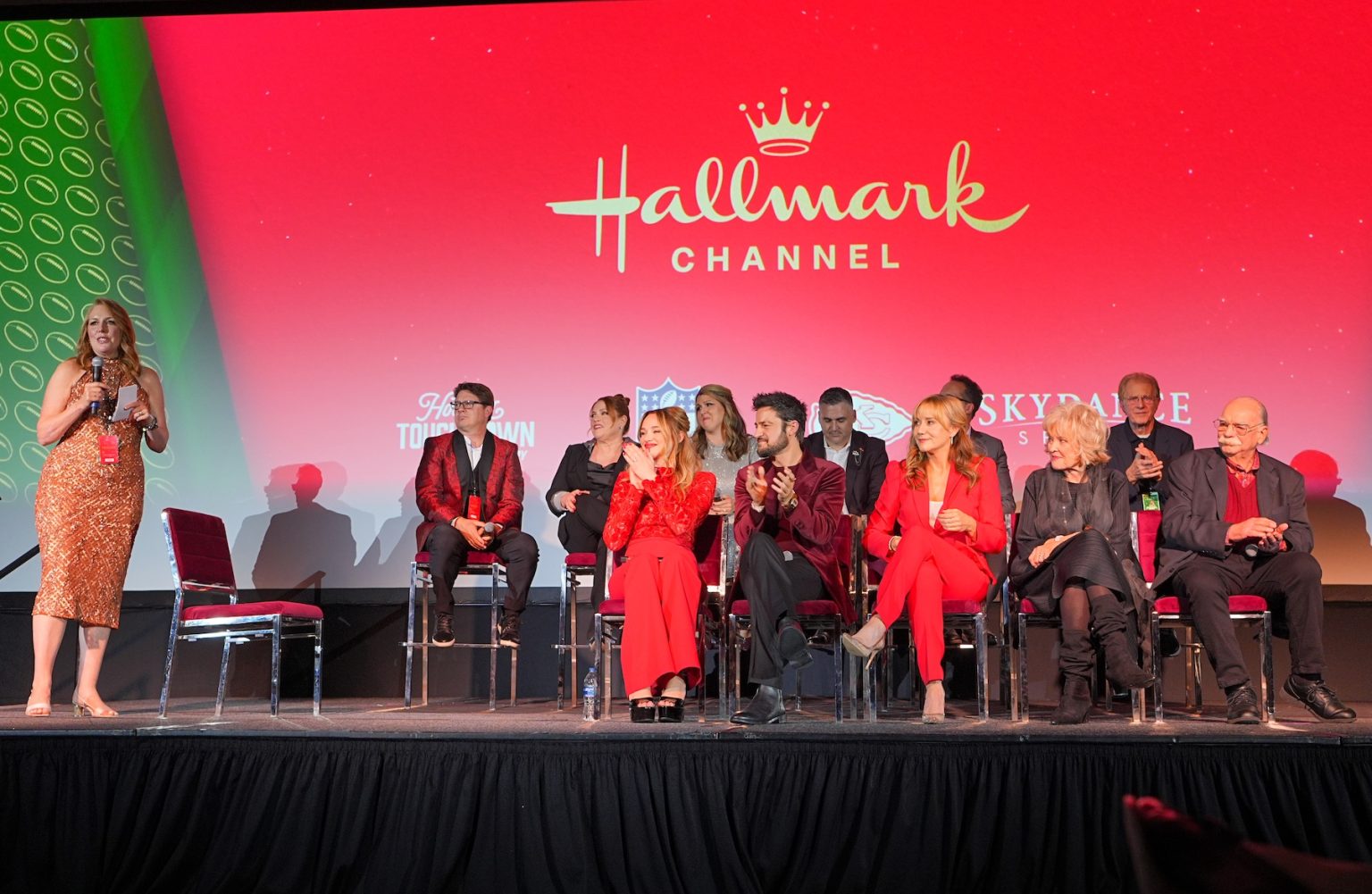 KANSAS CITY, MISSOURI - NOVEMBER 30: Panel Moderated by Annie Howell: On Panel: Back row: Julie Sherman, Wolfe, Samantha DiPippo, David Wulf, Diedrich Bader, Ed Begley Jr. Front Row: Hunter King, Tyler Hynes, Megyn Price, Christine Ebersole, Richard Riehl onstage during Hallmark's Premiere Screening of Holiday Touchdown: A Chiefs Love Story on November 30, 2024 in Kansas City, Missouri. (Photo by Kyle Rivas/Getty Images for Hallmark Media)