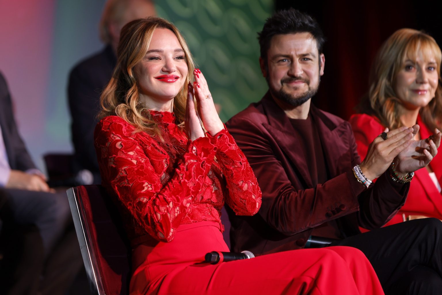 KANSAS CITY, MISSOURI - NOVEMBER 30: (L-R) Hunter King, Tyler Hynes and Megyn Price speak onstage during Hallmark's Premiere Screening of Holiday Touchdown: A Chiefs Love Story on November 30, 2024 in Kansas City, Missouri. (Photo by David Eulitt/Getty Images for Hallmark Media)