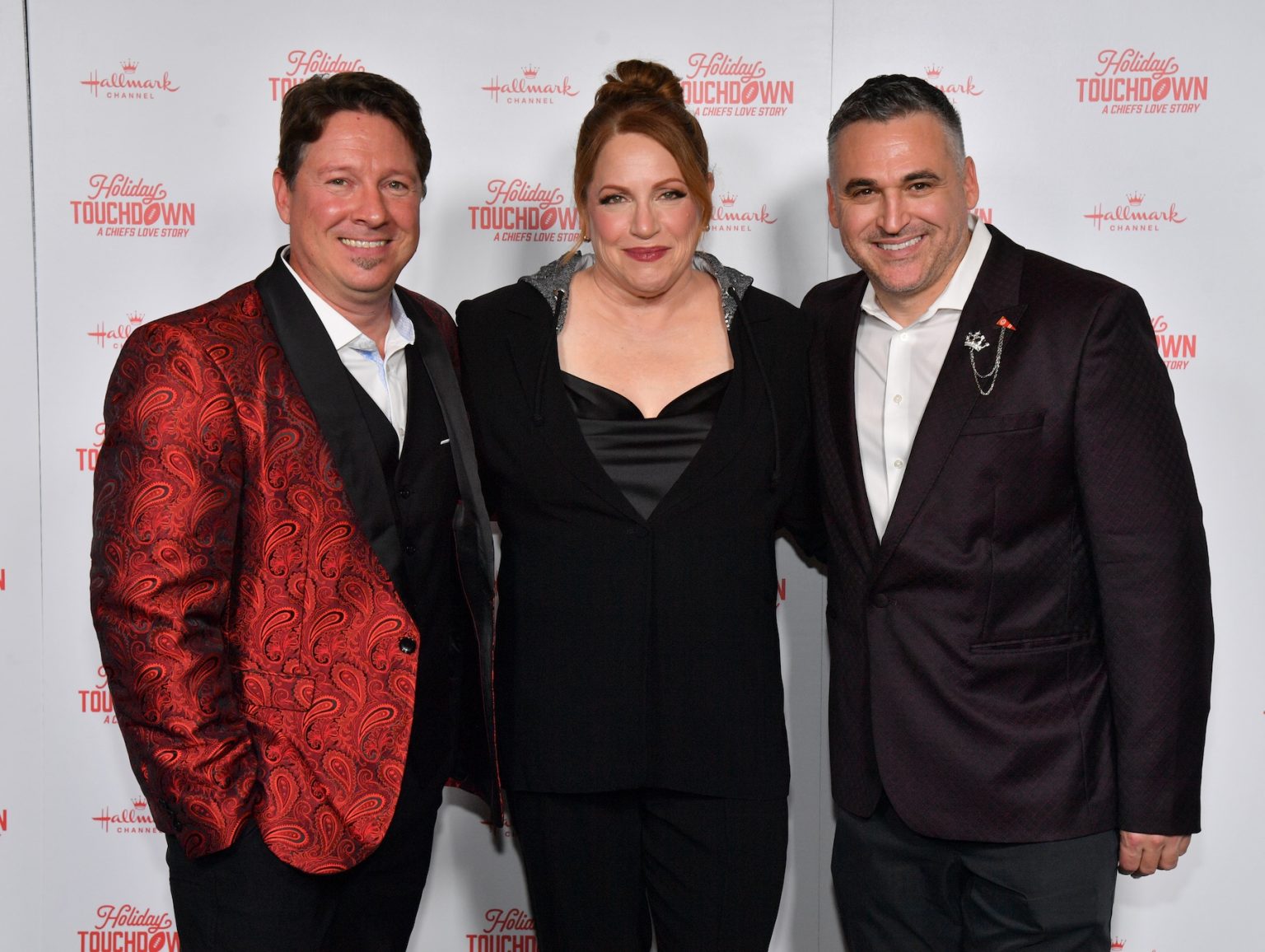 KANSAS CITY, MISSOURI - NOVEMBER 30: (L-R) Dustin Rikert, Julie Sherman Wolfe and David Wulf attend Hallmark's Premiere Screening of Holiday Touchdown: A Chiefs Love Story on November 30, 2024 in Kansas City, Missouri. (Photo by Jason Davis/Getty Images for Hallmark Media)