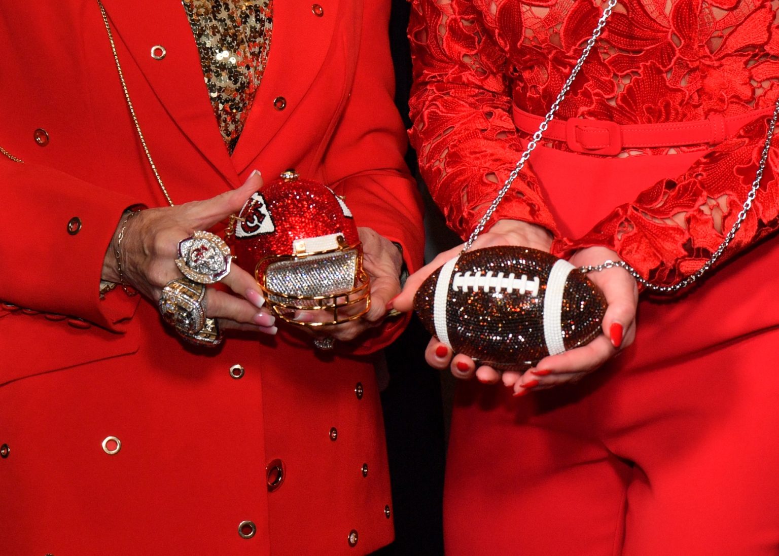 KANSAS CITY, MISSOURI - NOVEMBER 30: (L-R) Tammy Reid and Hunter King display football-themed purses during Hallmark's Premiere Screening of Holiday Touchdown: A Chiefs Love Story on November 30, 2024 in Kansas City, Missouri. (Photo by Jason Davis/Getty Images for Hallmark Media)
