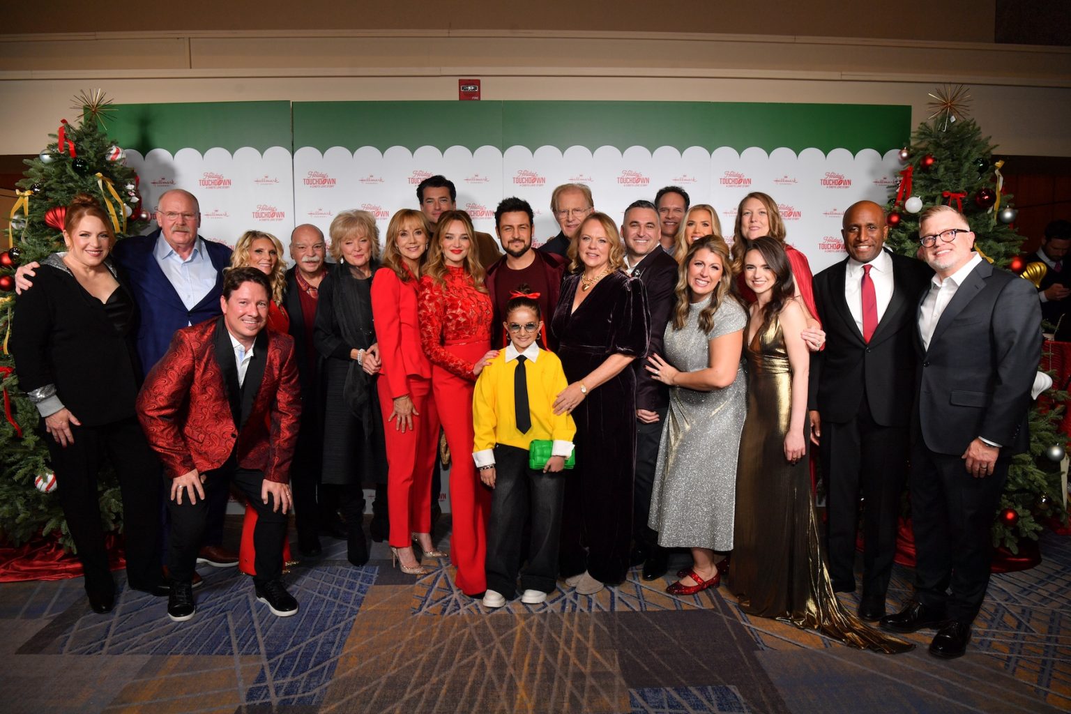 KANSAS CITY, MISSOURI - NOVEMBER 30: (L-R) Julie Sherman Wolfe, Andy Reid, Dustin Rikert, Tammy Reid, Richard Riehle, Christine Ebersole, Megyn Price, Wes Brown, Hunter King, Tyler Hynes, Taylen Biggs, Ed Begley Jr., Lisa Hamilton Daly, David Wulf, Diedrich Bader, Gracie Hunt, Samantha DiPippo, Candice DiLavore, Jennnifer Kramer, Kansas City Mayor Quinton Lucas and Darren Abbott attend the Hallmark's Premiere Screening of Holiday Touchdown: A Chiefs Love Story on November 30, 2024 in Kansas City, Missouri. (Photo by Jason Davis/Getty Images for Hallmark Media)