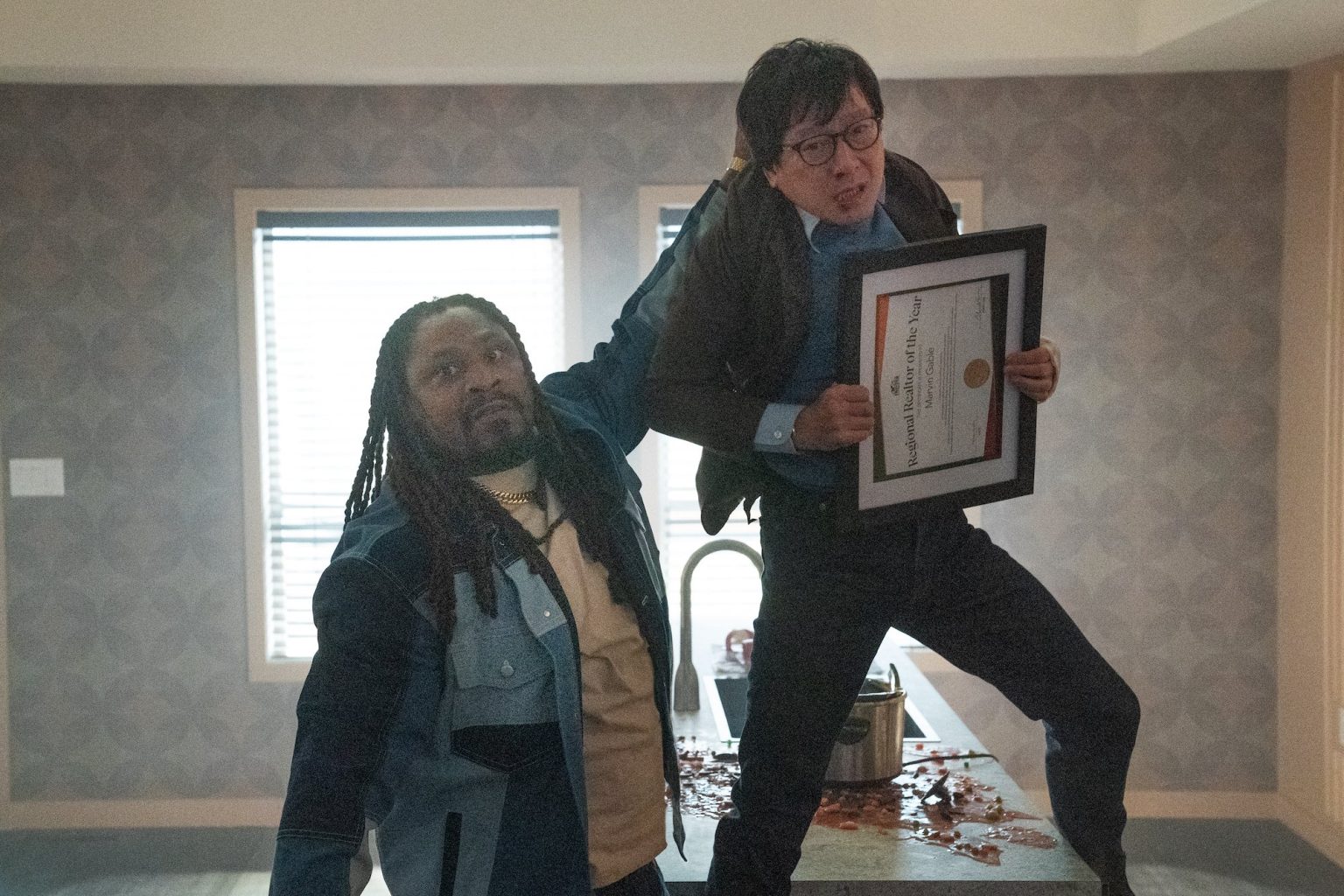 (from left) King (Marshawn “Beastmode” Lynch) and Marvin Gable (Ke Huy Quan) in Love Hurts, directed by Jonathan Eusebio.