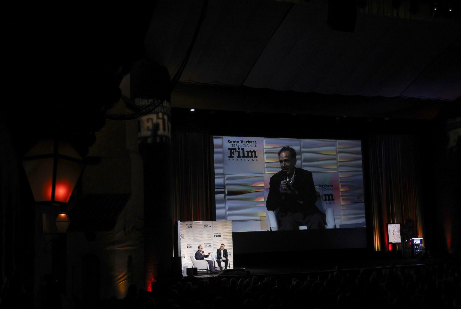 SANTA BARBARA, CALIFORNIA - FEBRUARY 06: Honoree Ralph Fiennes speaks onstage at the Outstanding Performer of the Year Award ceremony during the 40th Santa Barbara International Film Festival at Arlington Theatre on February 06, 2025 in Santa Barbara, California. (Photo by Tibrina Hobson/Getty Images for Santa Barbara International Film Festival)