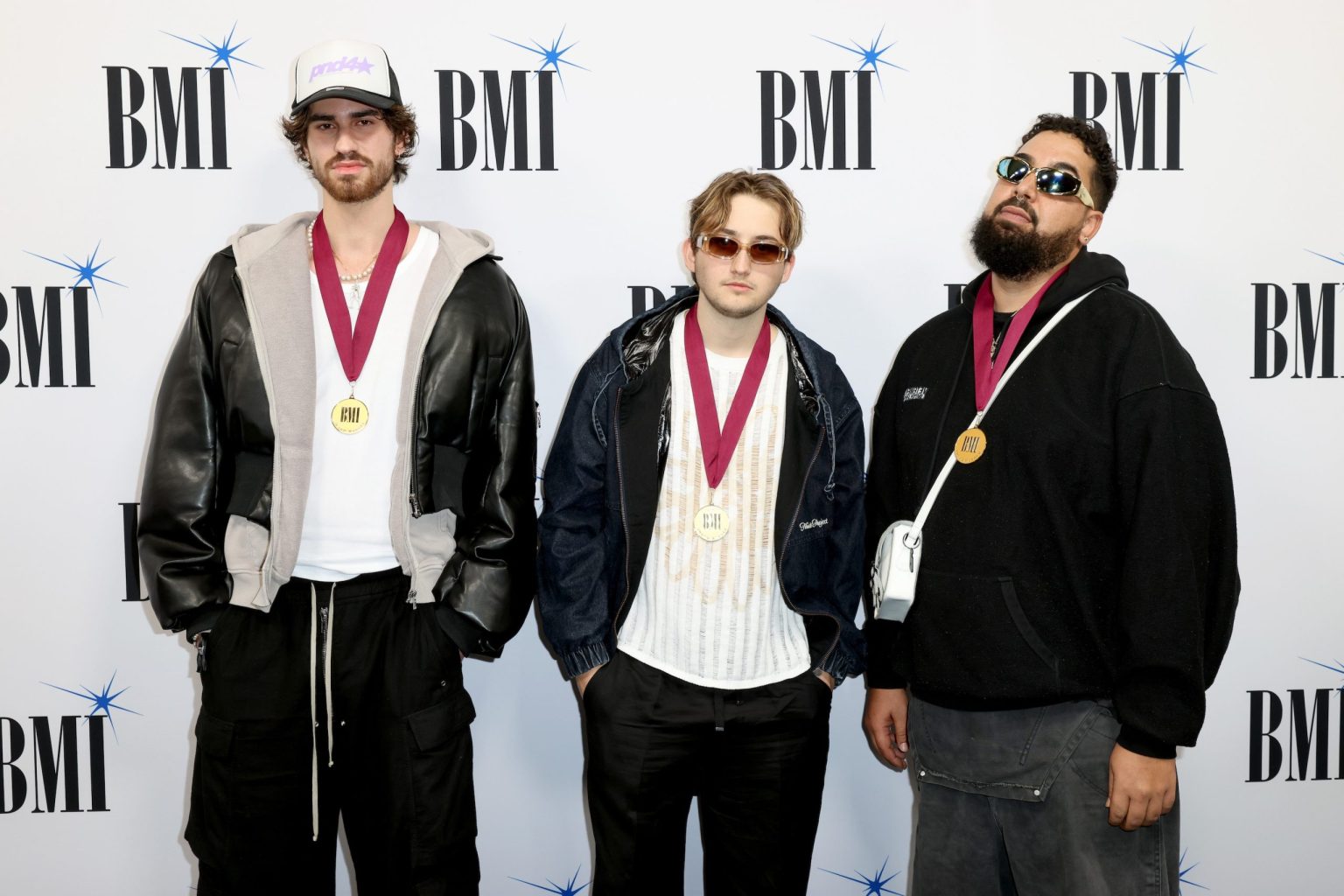 MIAMI, FLORIDA - MARCH 06: L-R) Harissis Tsakmaklis, Luzian Gregor Tuetsh and Feli.ciano of Bass Charity attend the BMI Latin Awards on March 06, 2025 in Miami, Florida. (Photo by Alexander Tamargo/Getty Images for BMI)