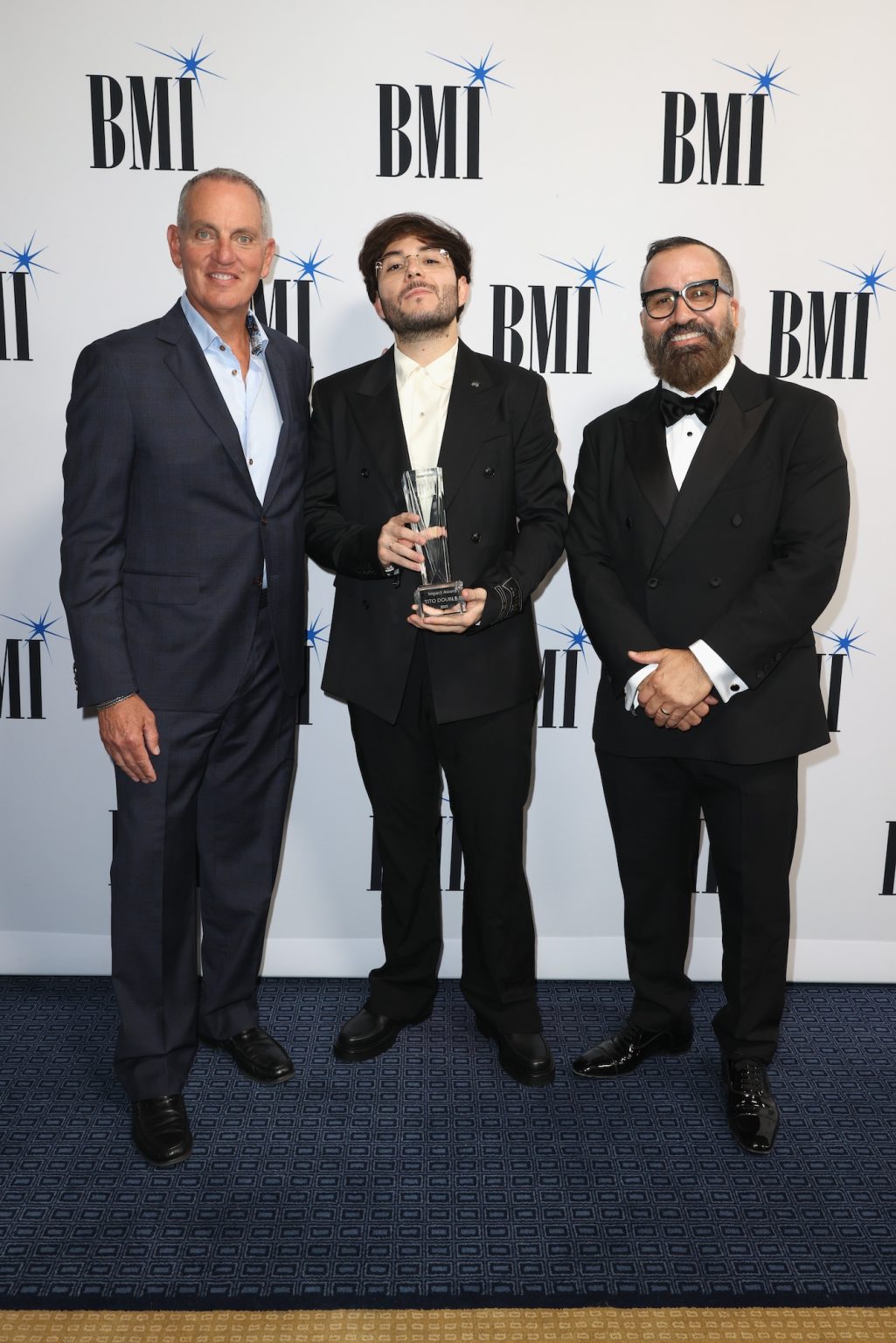 MIAMI, FLORIDA - MARCH 06: (L-R) Mike O'Neill, BMI President & CEO, Tito Double P and Jesus Gonzalez, BMI Vice President, Creative, Latin attend the BMI Latin Awards on March 06, 2025 in Miami, Florida. (Photo by Alexander Tamargo/Getty Images for BMI)