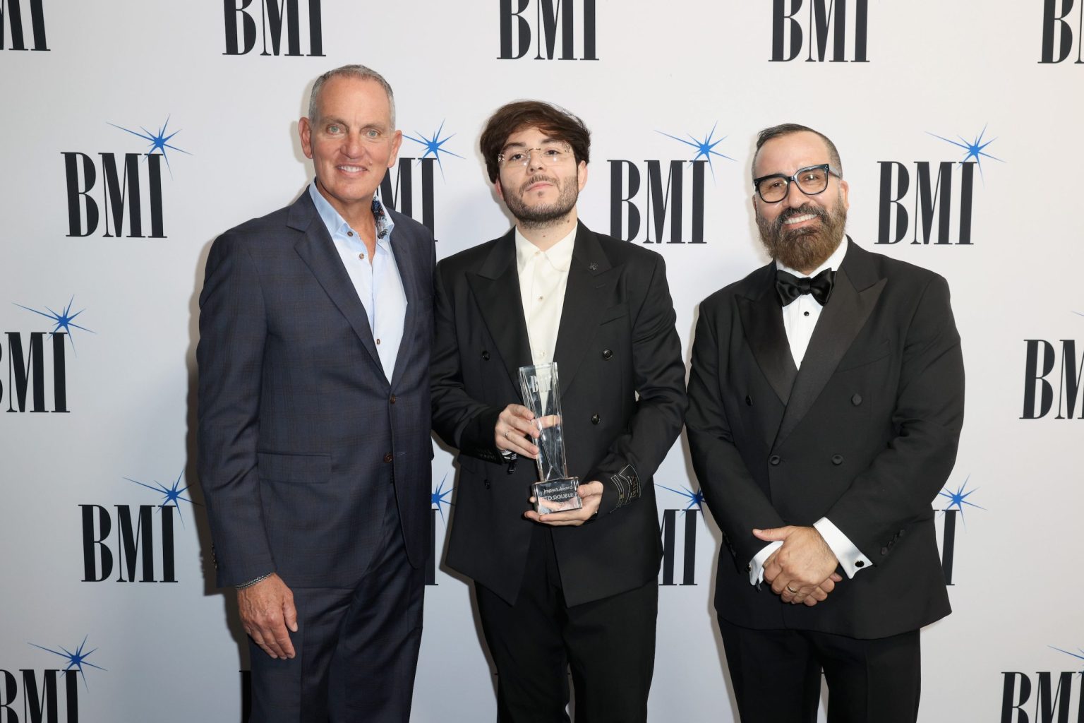 MIAMI, FLORIDA - MARCH 06: (L-R) Mike O'Neill, BMI President & CEO, Tito Double P and Jesus Gonzalez, BMI Vice President, Creative, Latin attend the BMI Latin Awards on March 06, 2025 in Miami, Florida. (Photo by Alexander Tamargo/Getty Images for BMI)