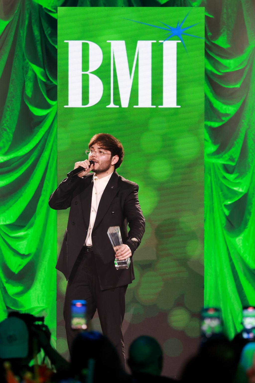 MIAMI, FLORIDA - MARCH 06: Tito Double P speaks onstage for the BMI Latin Awards on March 06, 2025 in Miami, Florida. (Photo by Rodrigo Varela/Getty Images for BMI)