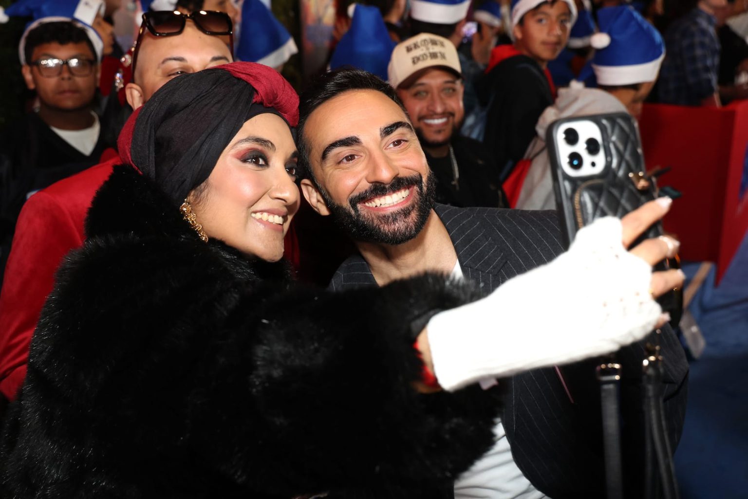 HOLLYWOOD, CALIFORNIA - DECEMBER 16: Lee Majdoub (R) poses with fans at the "Sonic The Hedgehog 3" Los Angeles premiere at the TCL Chinese Theatre on December 16, 2024, in Hollywood, California. (Photo by Phillip Faraone/Getty Images for Paramount Pictures)