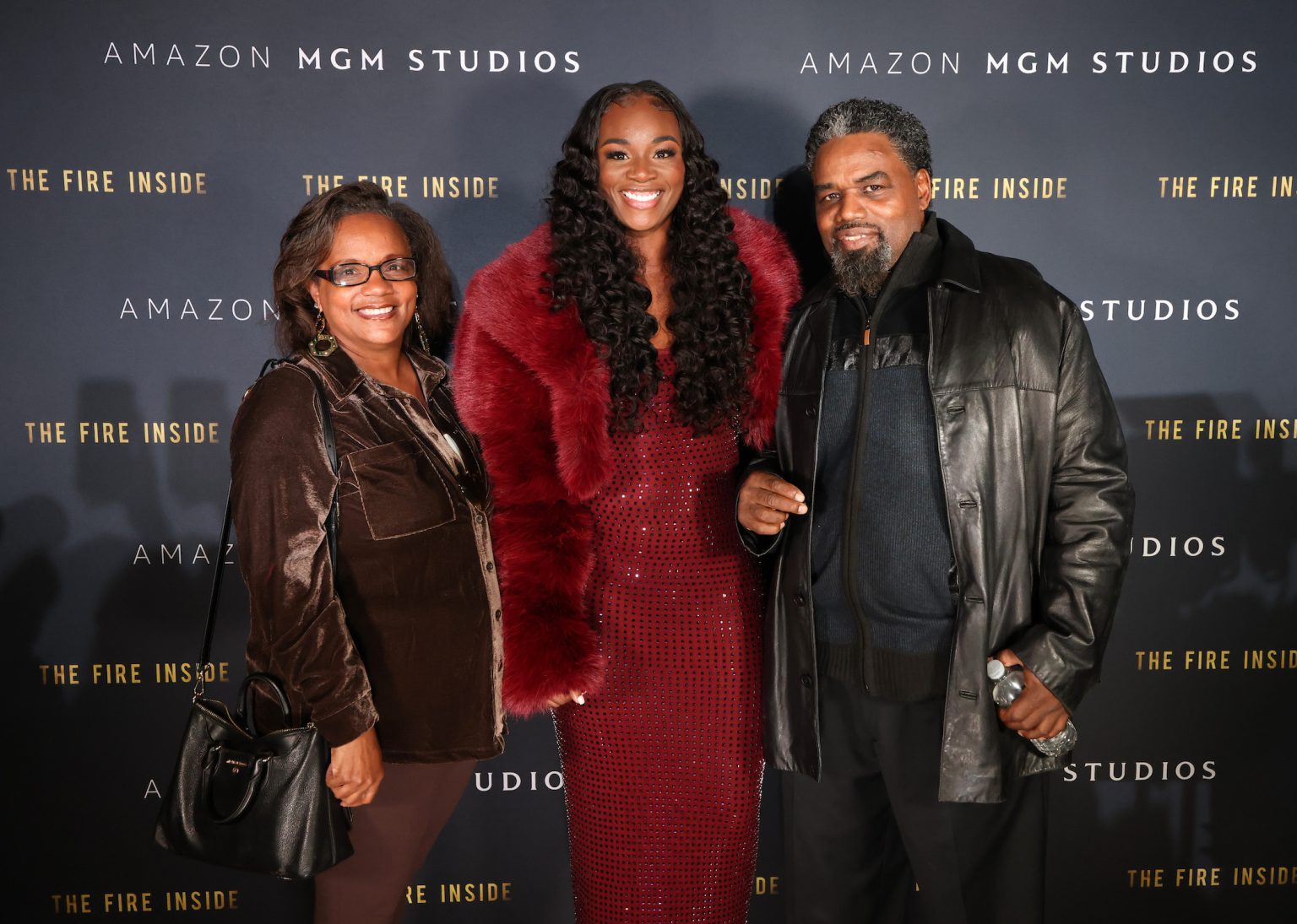 FLINT, MICHIGAN - NOVEMBER 10: (L-R) Guest, Claressa Shields, and Jason Crutchfield attend The Fire Inside – Flint Community Screening at Cinemark Flint West on November 10, 2024 in Flint, Michigan. (Photo by Scott Legato/Getty Images for The Fire Inside)
