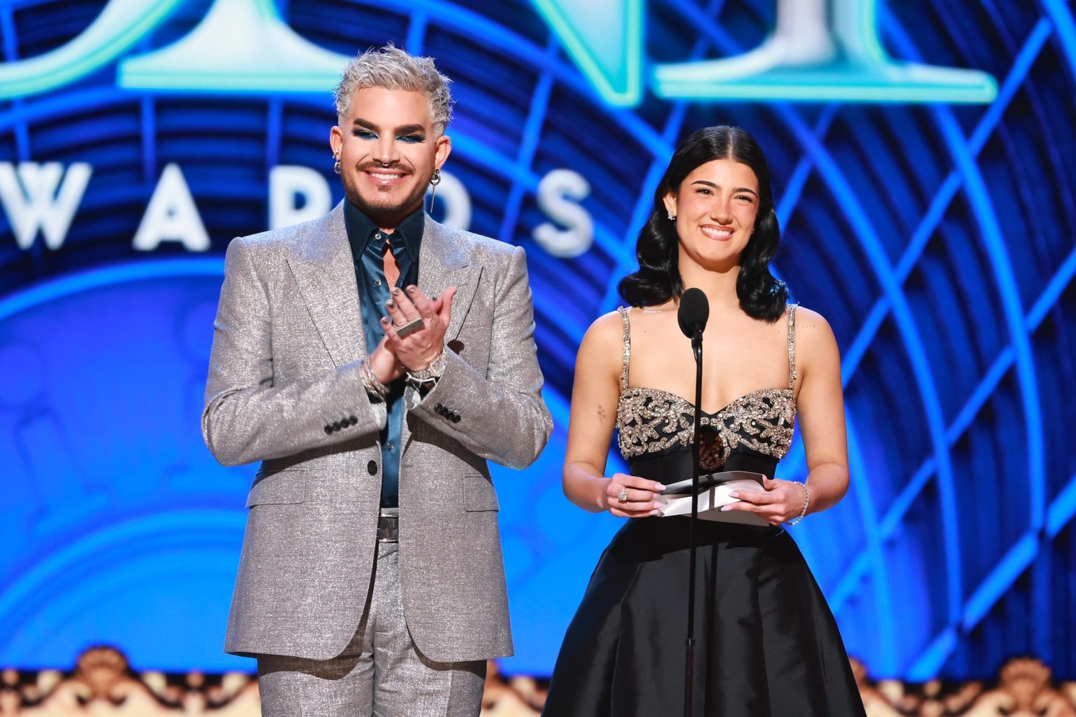 NEW YORK, NEW YORK - JUNE 08: (L-R) Adam Lambert and Charli D'Amelio speak onstage during The 78th Annual Tony Awards at Radio City Music Hall on June 08, 2025 in New York City. (Photo by Theo Wargo/Getty Images for Tony Awards Productions)