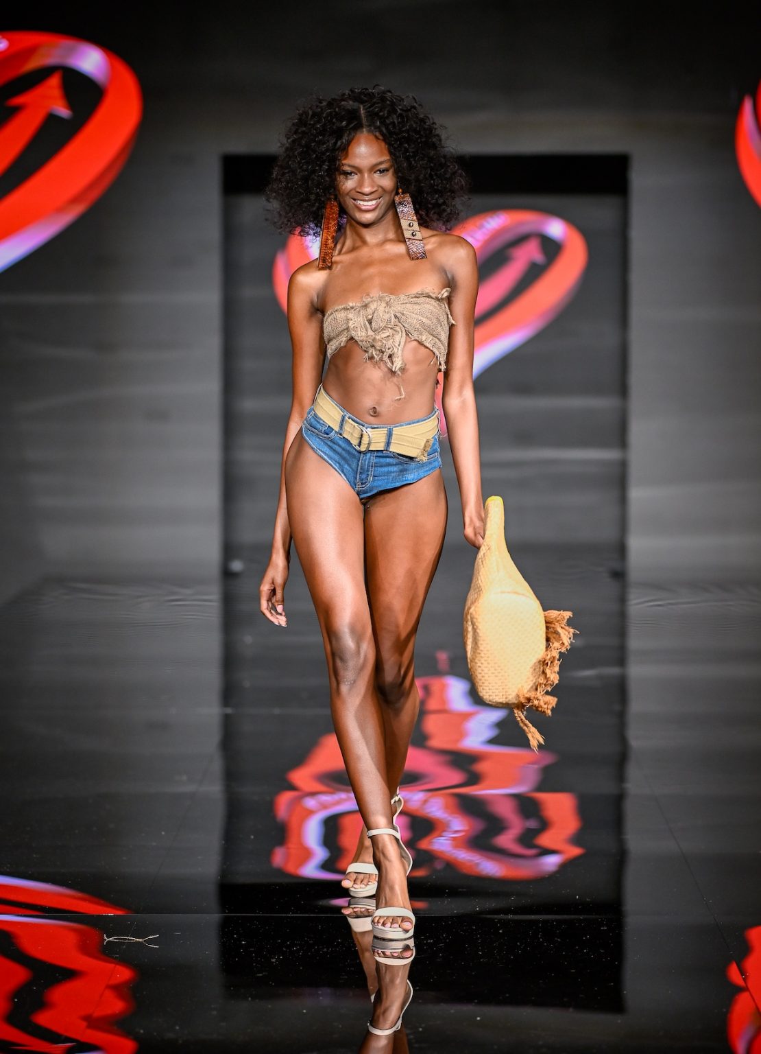MIAMI BEACH, FLORIDA - MAY 31: A model walks the runway at the Love For Upcycling show during Miami Swim Week Powered By Art Hearts Fashion at Eden Roc Hotel on May 31, 2025 in Miami Beach, Florida. (Photo by Arun Nevader/Getty Images for Art Hearts Fashion)