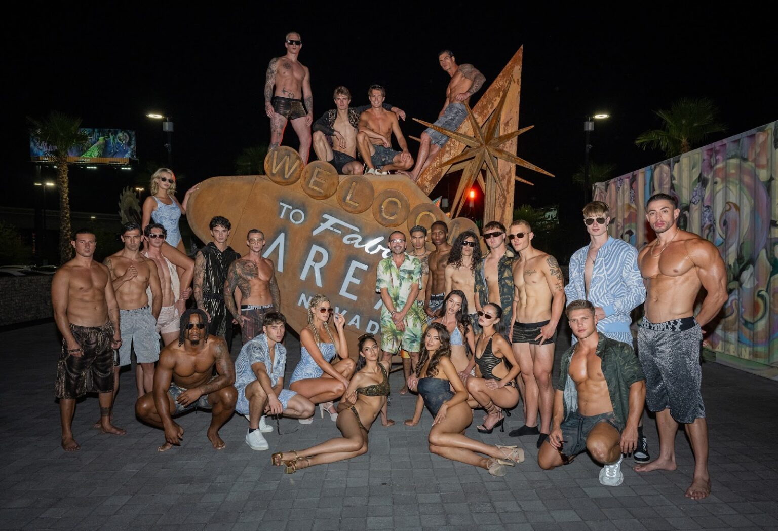 Art Hearts Fashion President & Mister Triple X Designer Erik Rosete poses with models outside of AREA15