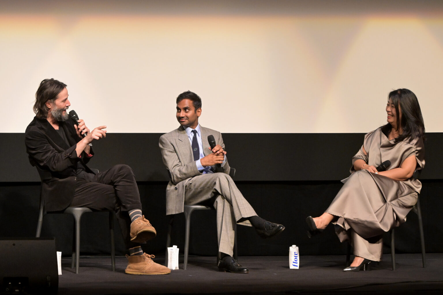TORONTO, ONTARIO - SEPTEMBER 06: (L-R) Keanu Reeves, Aziz Ansari, and Anita Lee speak onstage during the “Good Fortune” World Premiere at the Toronto International Film Festival on September 06, 2025 in Toronto, Ontario. (Photo by Vivien Killilea/Getty Images for Lionsgate)