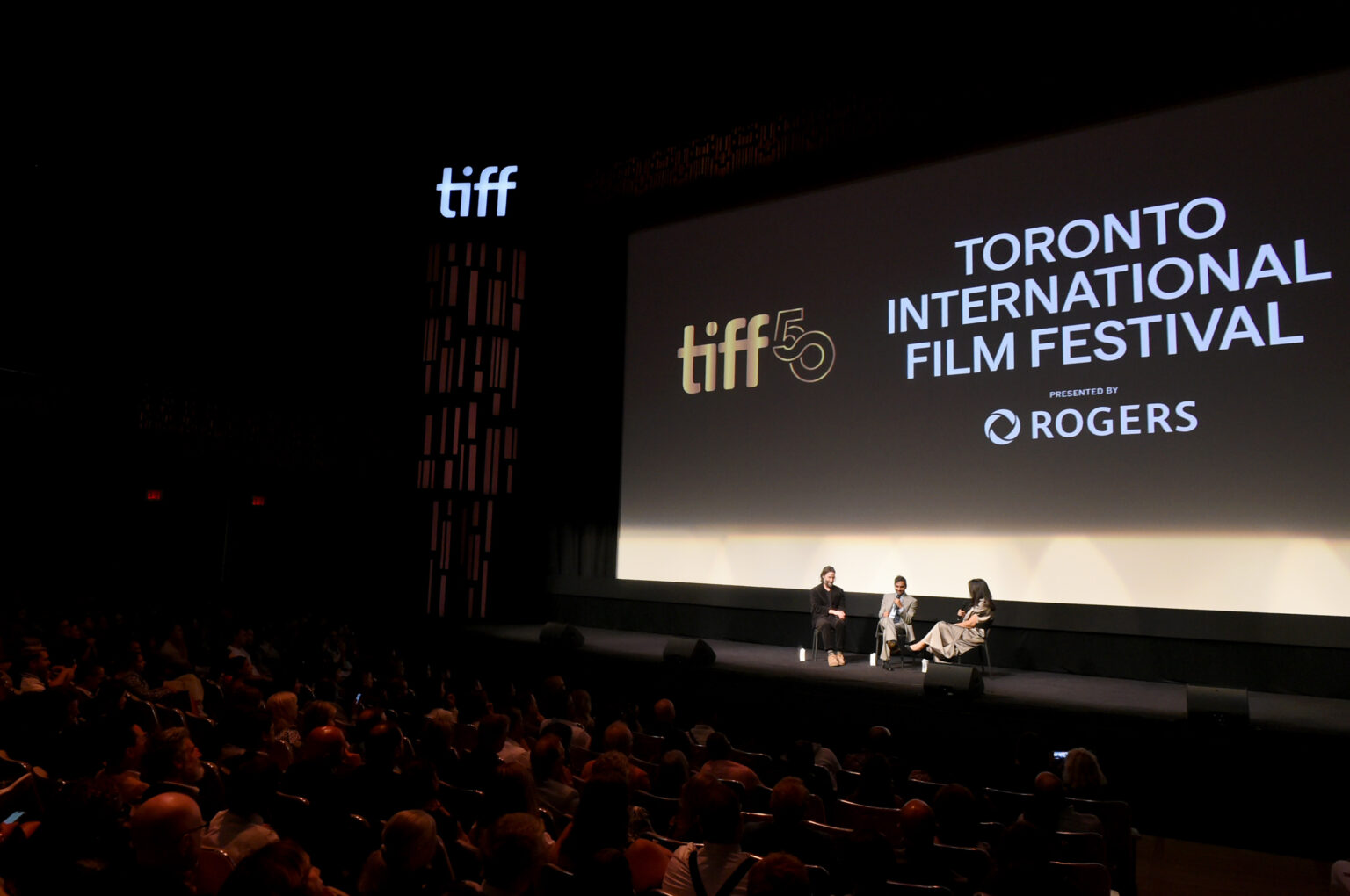 TORONTO, ONTARIO - SEPTEMBER 06: (L-R) Keanu Reeves, Aziz Ansari, and Anita Lee speak onstage during the “Good Fortune” World Premiere at the Toronto International Film Festival on September 06, 2025 in Toronto, Ontario. (Photo by Vivien Killilea/Getty Images for Lionsgate)