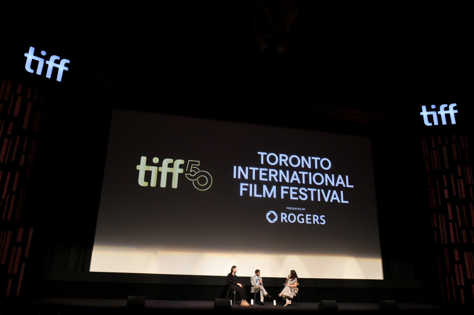TORONTO, ONTARIO - SEPTEMBER 06: (L-R) Keanu Reeves, Aziz Ansari, and Anita Lee speak onstage during the “Good Fortune” World Premiere at the Toronto International Film Festival on September 06, 2025 in Toronto, Ontario. (Photo by Vivien Killilea/Getty Images for Lionsgate)