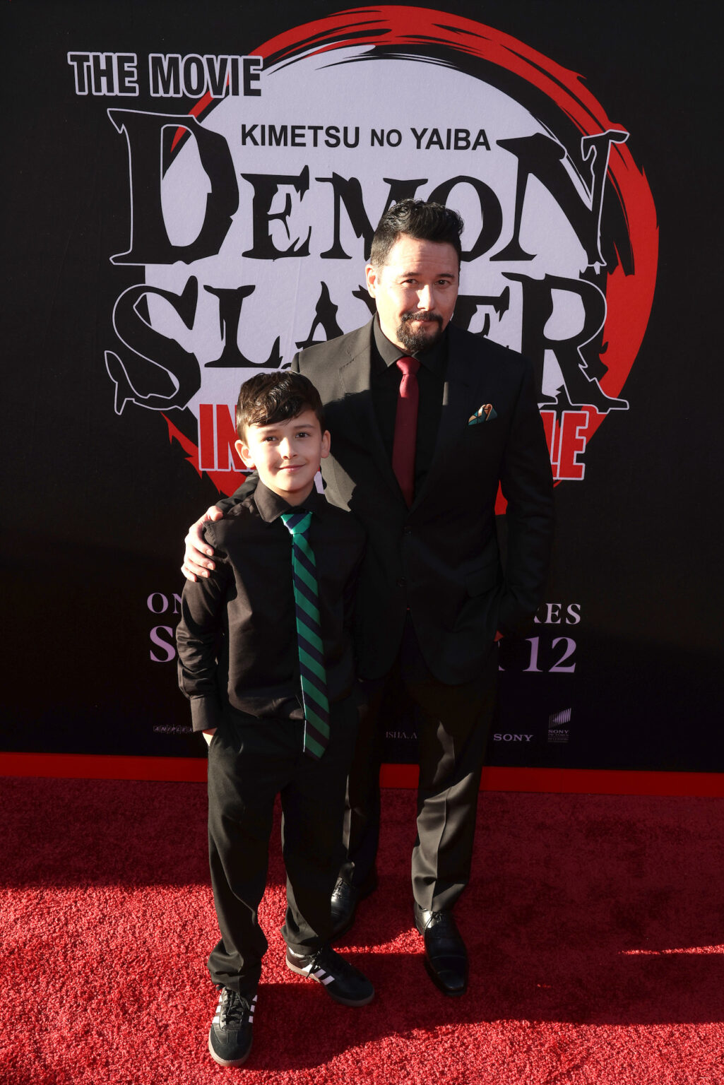 HOLLYWOOD, CALIFORNIA - SEPTEMBER 09: Johnny Yong Bosch (R) and guest attend the Los Angeles premiere of "Demon Slayer: Kimetsu No Yaiba Infinity Castle" at TCL Chinese Theatre on September 09, 2025 in Hollywood, California. (Photo by Randy Shropshire/Getty Images for Crunchyroll, Sony Pictures Entertainment, Aniplex)