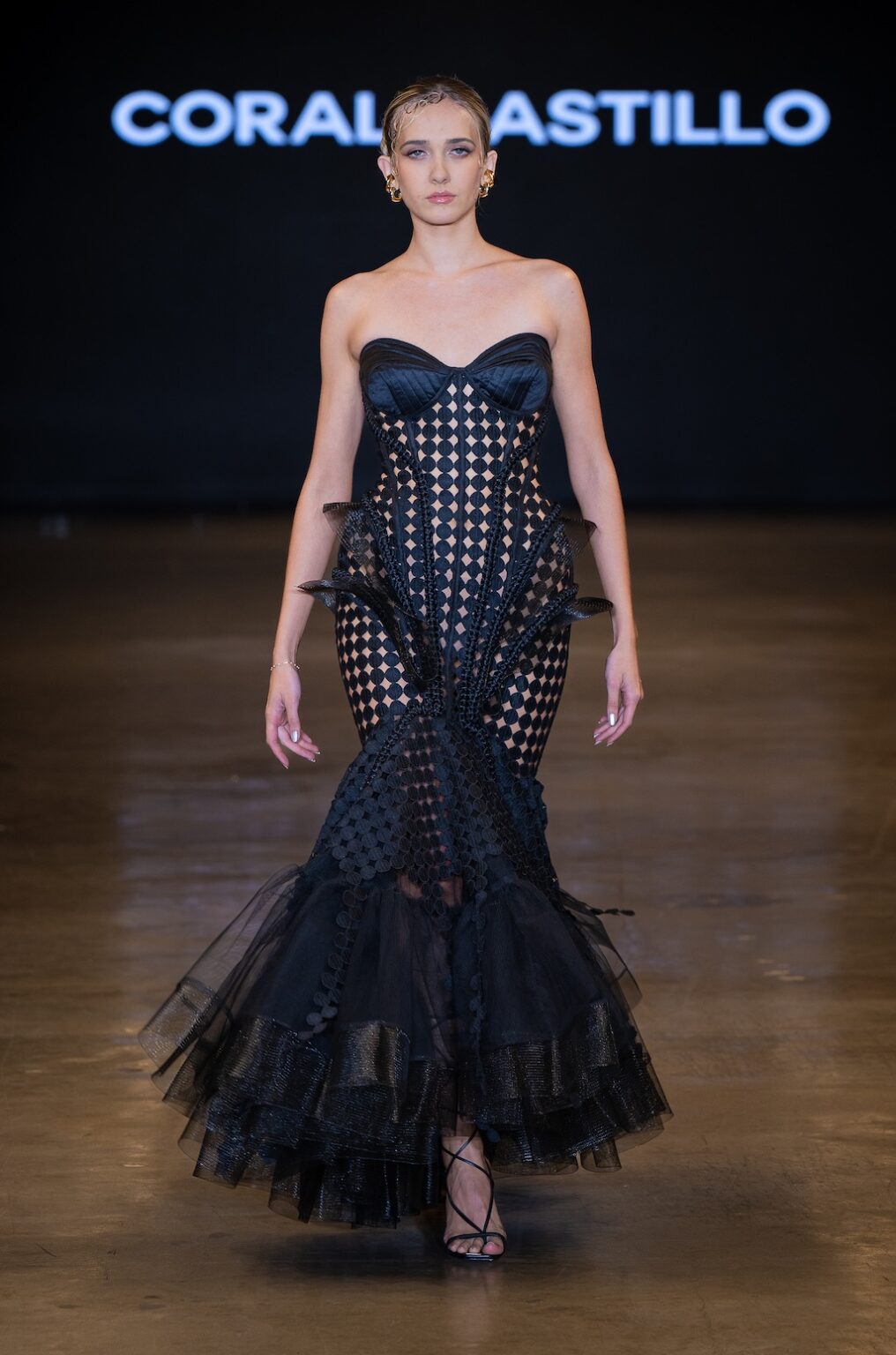 LOS ANGELES, CALIFORNIA - OCTOBER 16: A model walks the runway at the Coral Castillo show during Los Angeles Fashion Week Powered By Art Hearts Fashion at The New Mart on October 16, 2025 in Los Angeles, California. (Photo by Mark Gunter/Getty Images for Art Hearts Fashion)