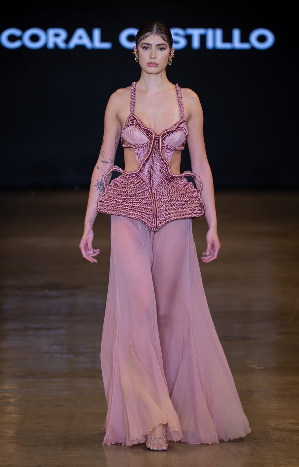 LOS ANGELES, CALIFORNIA - OCTOBER 16: A model walks the runway at the Coral Castillo show during Los Angeles Fashion Week Powered By Art Hearts Fashion at The New Mart on October 16, 2025 in Los Angeles, California. (Photo by Mark Gunter/Getty Images for Art Hearts Fashion)