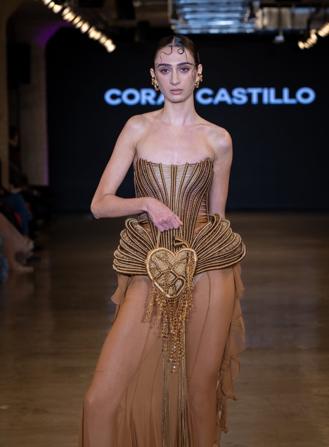 LOS ANGELES, CALIFORNIA - OCTOBER 16: A model walks the runway at the Coral Castillo show during Los Angeles Fashion Week Powered By Art Hearts Fashion at The New Mart on October 16, 2025 in Los Angeles, California. (Photo by Mark Gunter/Getty Images for Art Hearts Fashion)