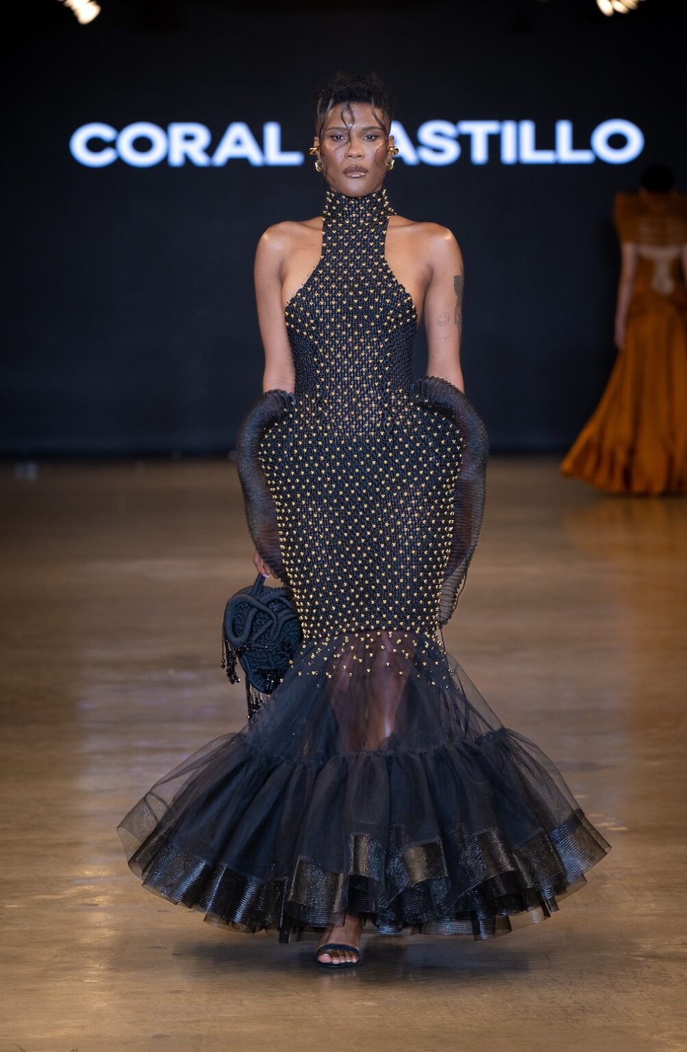 LOS ANGELES, CALIFORNIA - OCTOBER 16: A model walks the runway at the Coral Castillo show during Los Angeles Fashion Week Powered By Art Hearts Fashion at The New Mart on October 16, 2025 in Los Angeles, California. (Photo by Mark Gunter/Getty Images for Art Hearts Fashion)