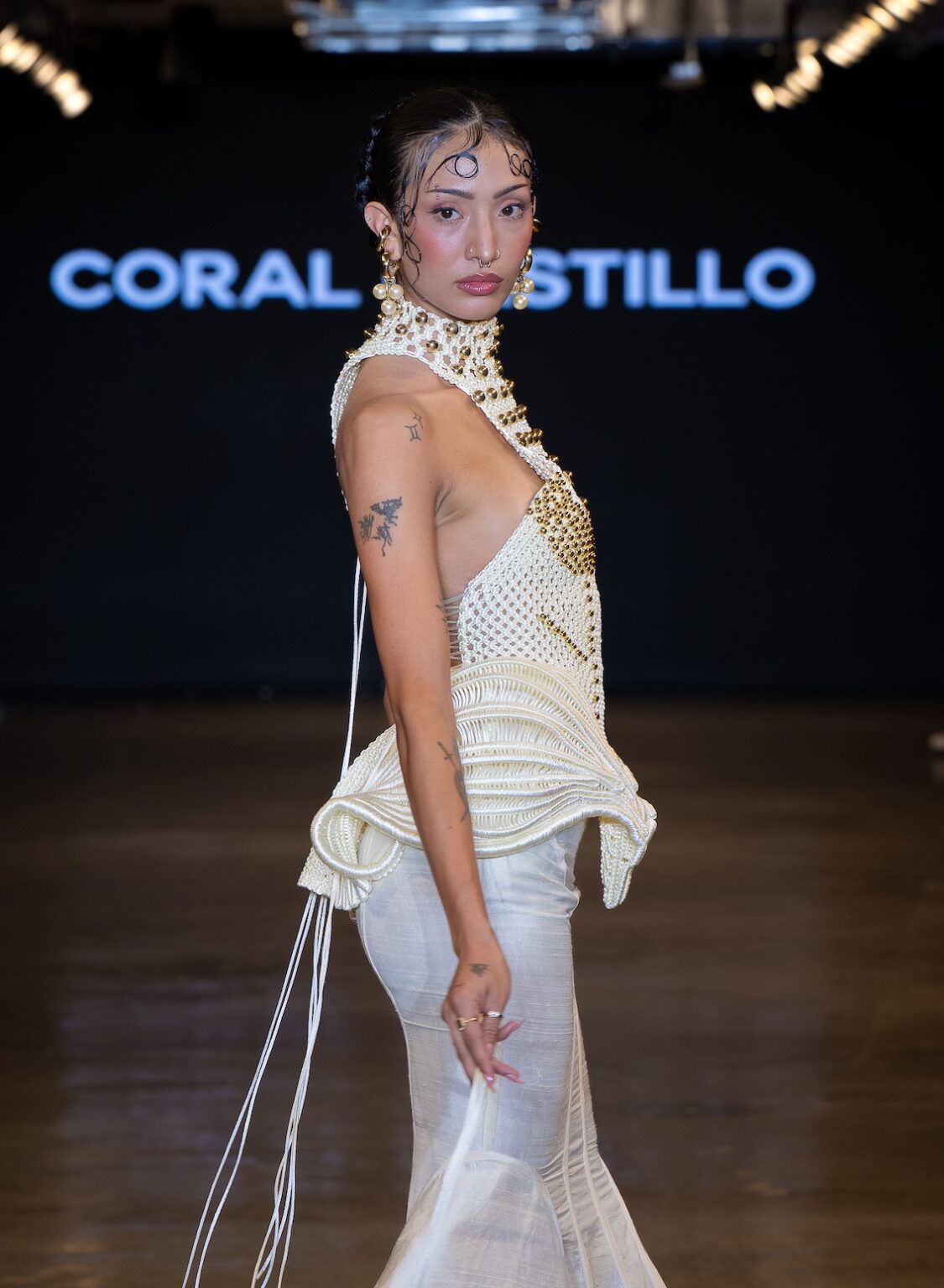 LOS ANGELES, CALIFORNIA - OCTOBER 16: A model walks the runway at the Coral Castillo show during Los Angeles Fashion Week Powered By Art Hearts Fashion at The New Mart on October 16, 2025 in Los Angeles, California. (Photo by Mark Gunter/Getty Images for Art Hearts Fashion)
