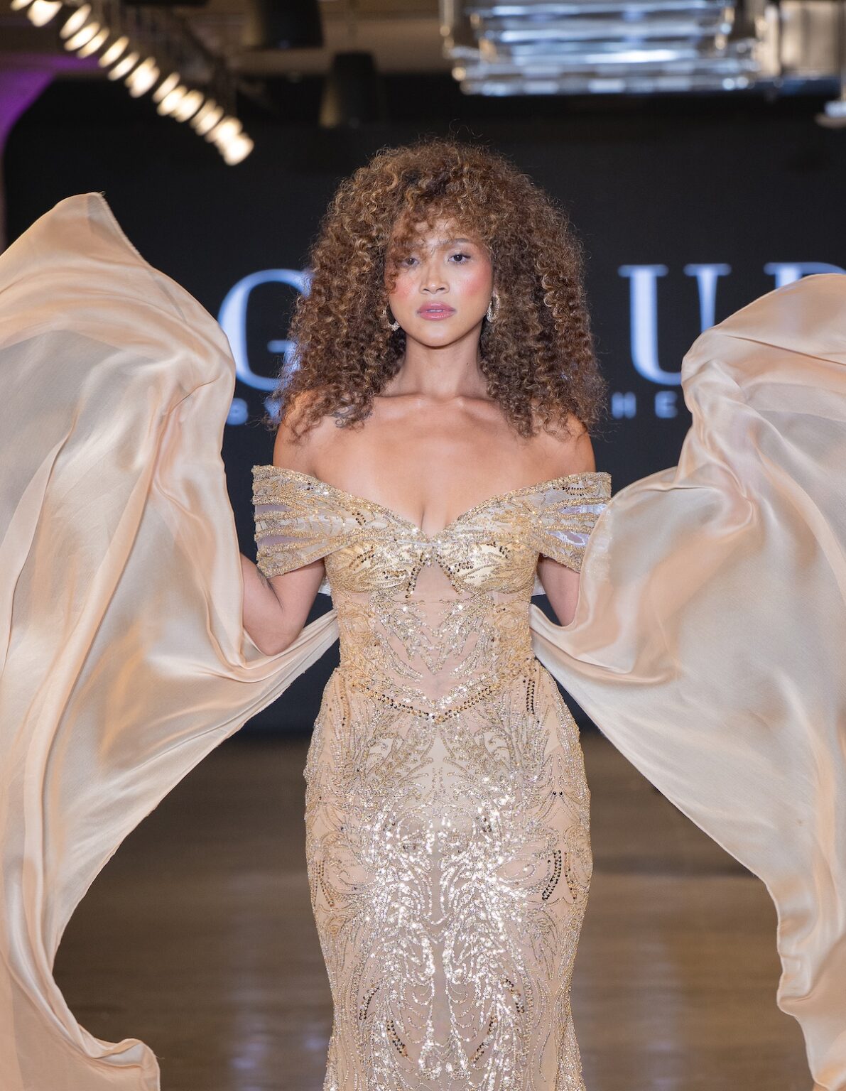 LOS ANGELES, CALIFORNIA - OCTOBER 16: A model walks the runway at the Glaudi show during Los Angeles Fashion Week Powered By Art Hearts Fashion at The New Mart on October 16, 2025 in Los Angeles, California. (Photo by Mark Gunter/Getty Images for Art Hearts Fashion)