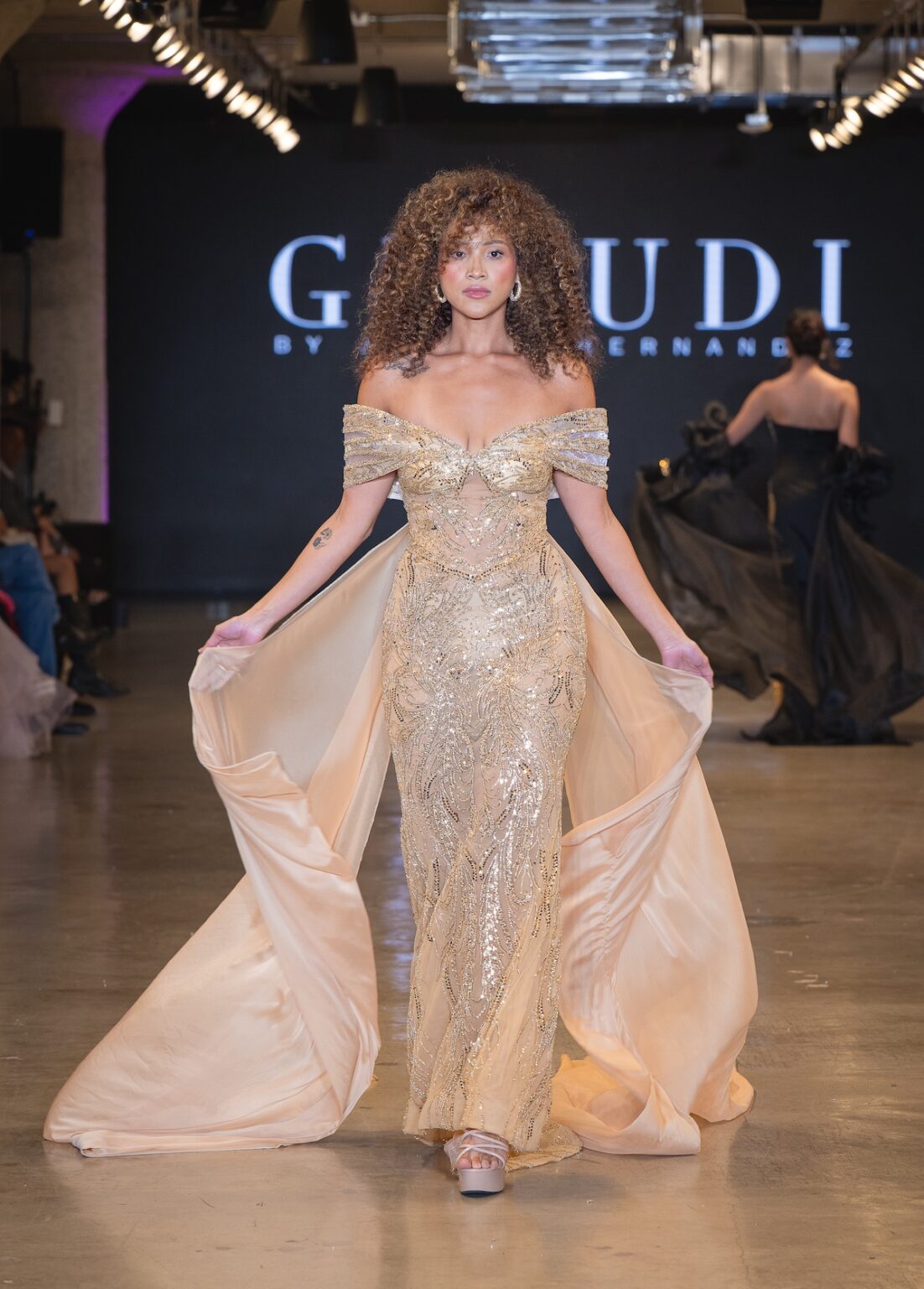 LOS ANGELES, CALIFORNIA - OCTOBER 16: A model walks the runway at the Glaudi show during Los Angeles Fashion Week Powered By Art Hearts Fashion at The New Mart on October 16, 2025 in Los Angeles, California. (Photo by Mark Gunter/Getty Images for Art Hearts Fashion)