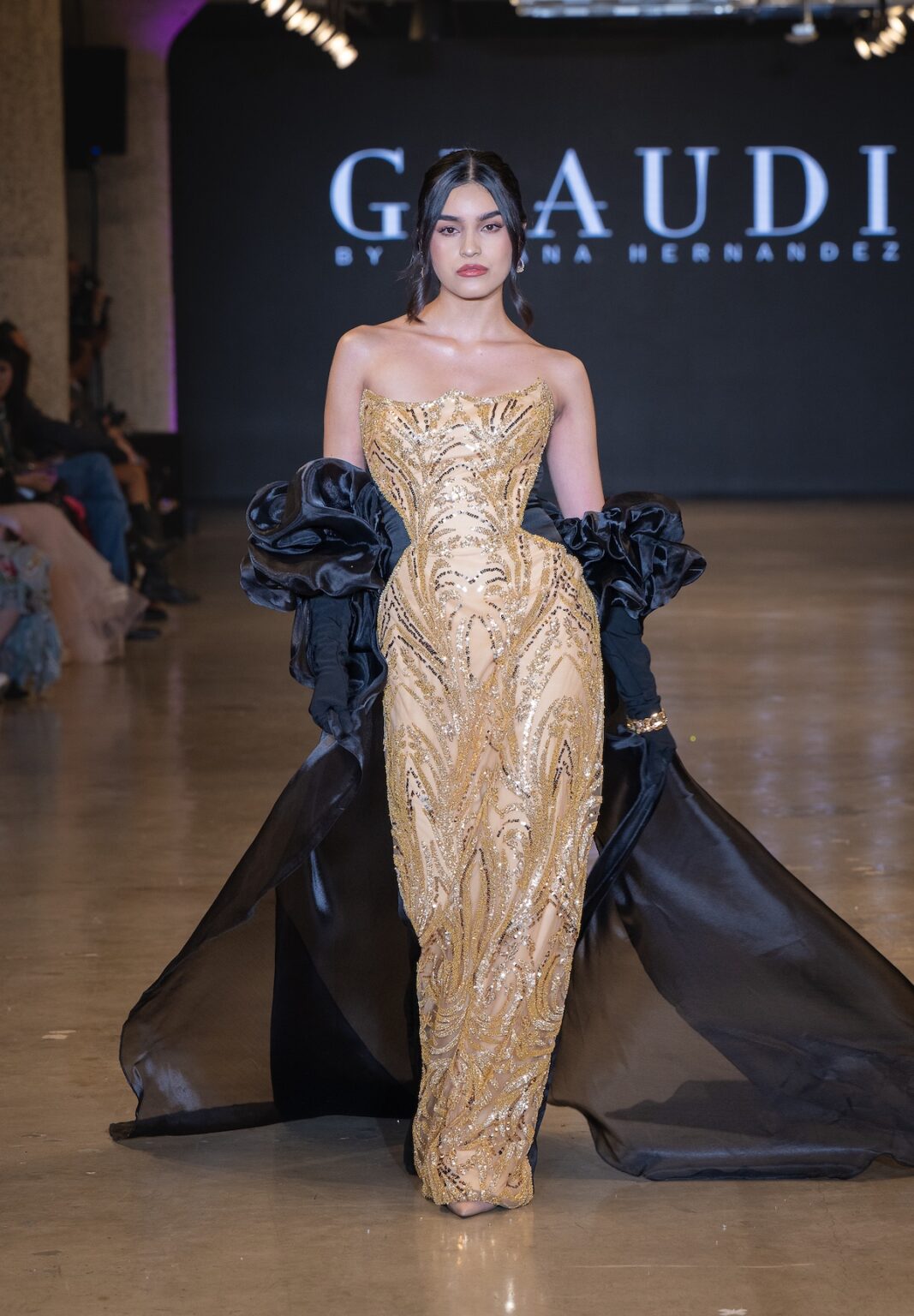 LOS ANGELES, CALIFORNIA - OCTOBER 16: A model walks the runway at the Glaudi show during Los Angeles Fashion Week Powered By Art Hearts Fashion at The New Mart on October 16, 2025 in Los Angeles, California. (Photo by Mark Gunter/Getty Images for Art Hearts Fashion)