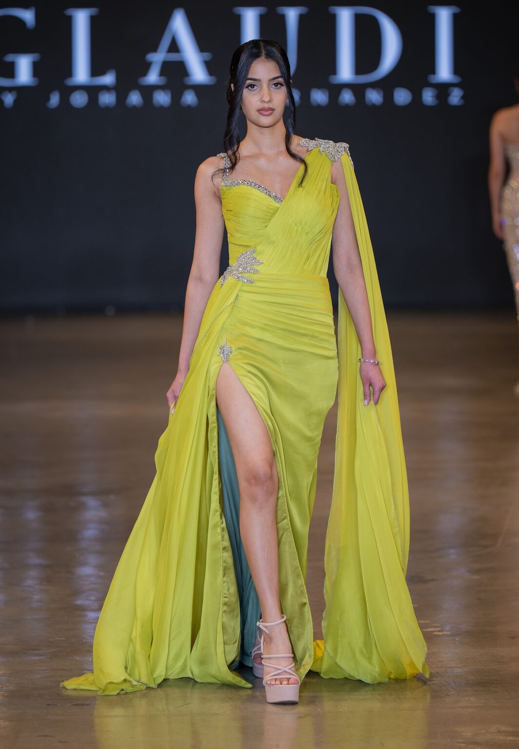 LOS ANGELES, CALIFORNIA - OCTOBER 16: A model walks the runway at the Glaudi show during Los Angeles Fashion Week Powered By Art Hearts Fashion at The New Mart on October 16, 2025 in Los Angeles, California. (Photo by Mark Gunter/Getty Images for Art Hearts Fashion)