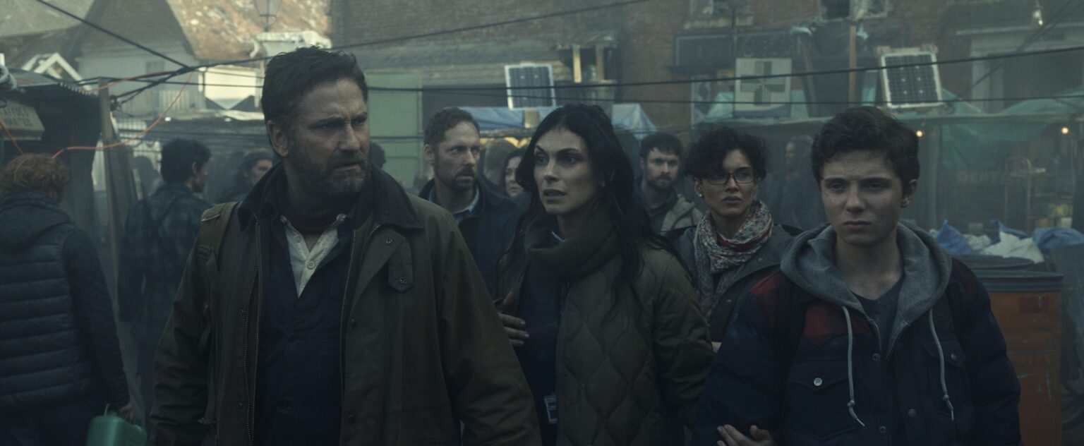 Gerard Butler as John Garrity, Morena Baccarin as Allison Garrity, Amber Rose Revah as Dr. Casey Amina, and Roman Griffin Davis as Nathan Garrity in Greenland 2: Migration. Photo Credit: Courtesy of Lionsgate