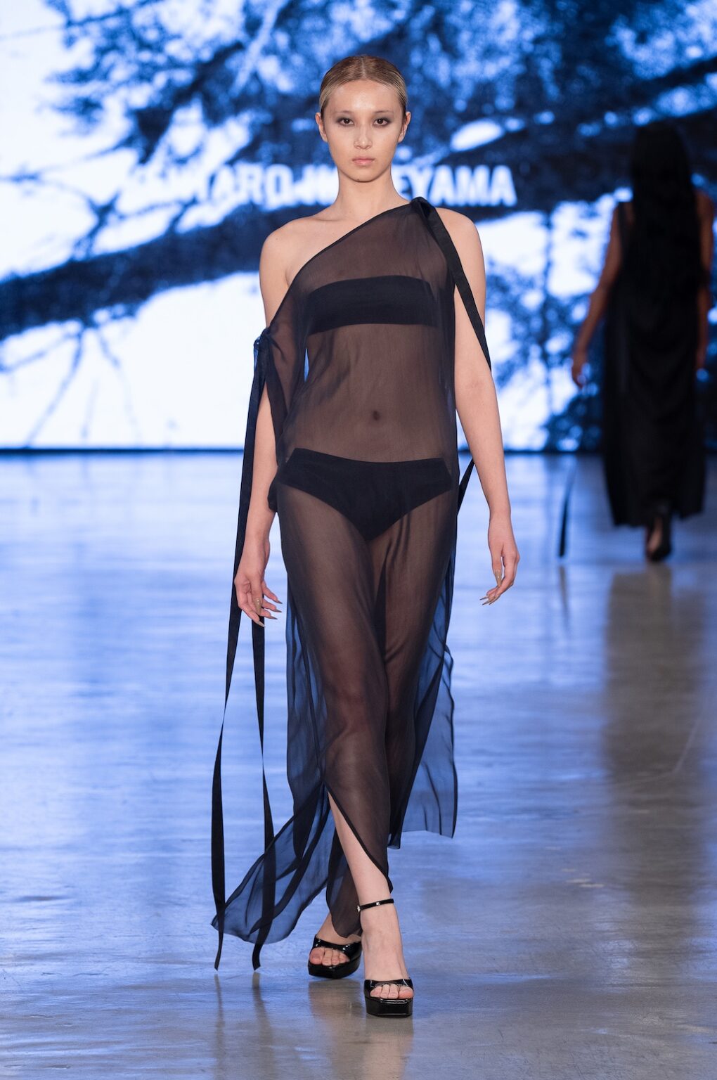 LOS ANGELES, CALIFORNIA - OCTOBER 17: A model walks the runway at the Kentaro Kameyama show during Los Angeles Fashion Week Powered By Art Hearts Fashion at The New Mart on October 17, 2025 in Los Angeles, California. (Photo by Mark Gunter/Getty Images for Art Hearts Fashion)