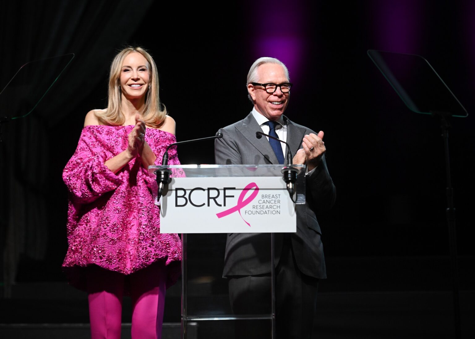 NEW YORK, NEW YORK - OCTOBER 30: (L-R) Dee Ocleppo Hilfiger and Tommy Hilfiger speak onstage at the Breast Cancer Research Foundation New York Symposium & Awards Luncheon at New York Hilton Midtown on October 30, 2025 in New York City. (Photo by Noam Galai/Getty Images for Breast Cancer Research Foundation) PHOTO BY NOAM GALAI