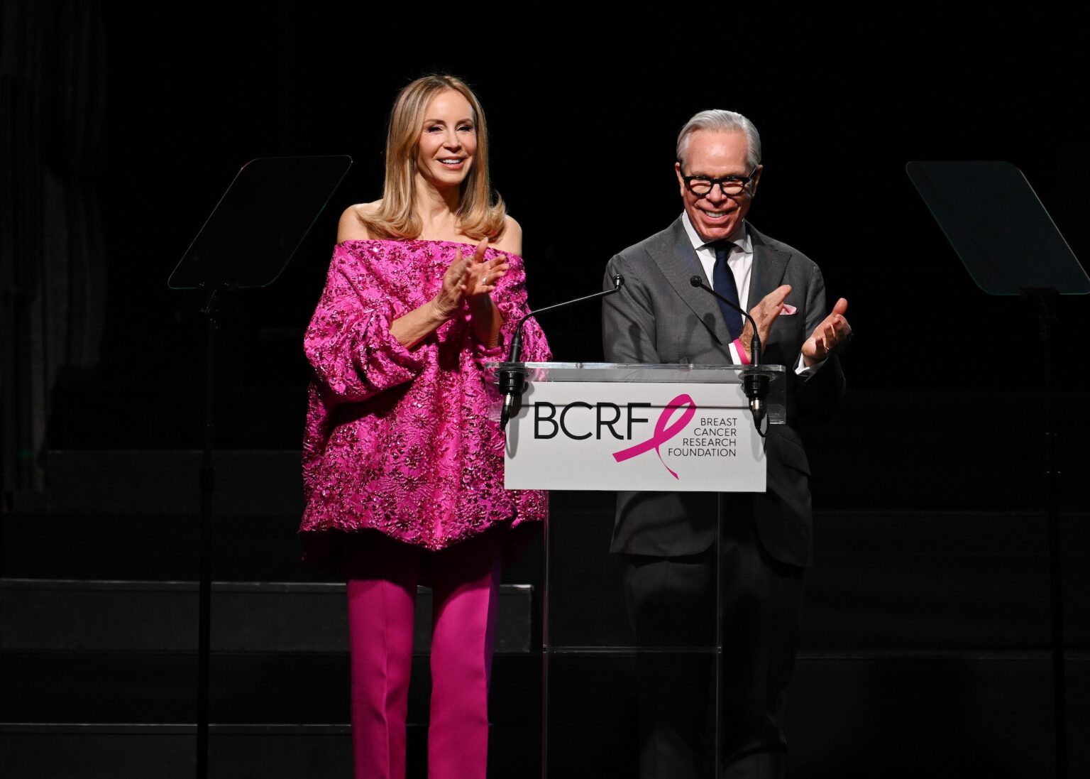 NEW YORK, NEW YORK - OCTOBER 30: (L-R) Dee Ocleppo Hilfiger and Tommy Hilfiger speak onstage at the Breast Cancer Research Foundation New York Symposium & Awards Luncheon at New York Hilton Midtown on October 30, 2025 in New York City. (Photo by Bryan Bedder/Getty Images for Breast Cancer Research Foundation)