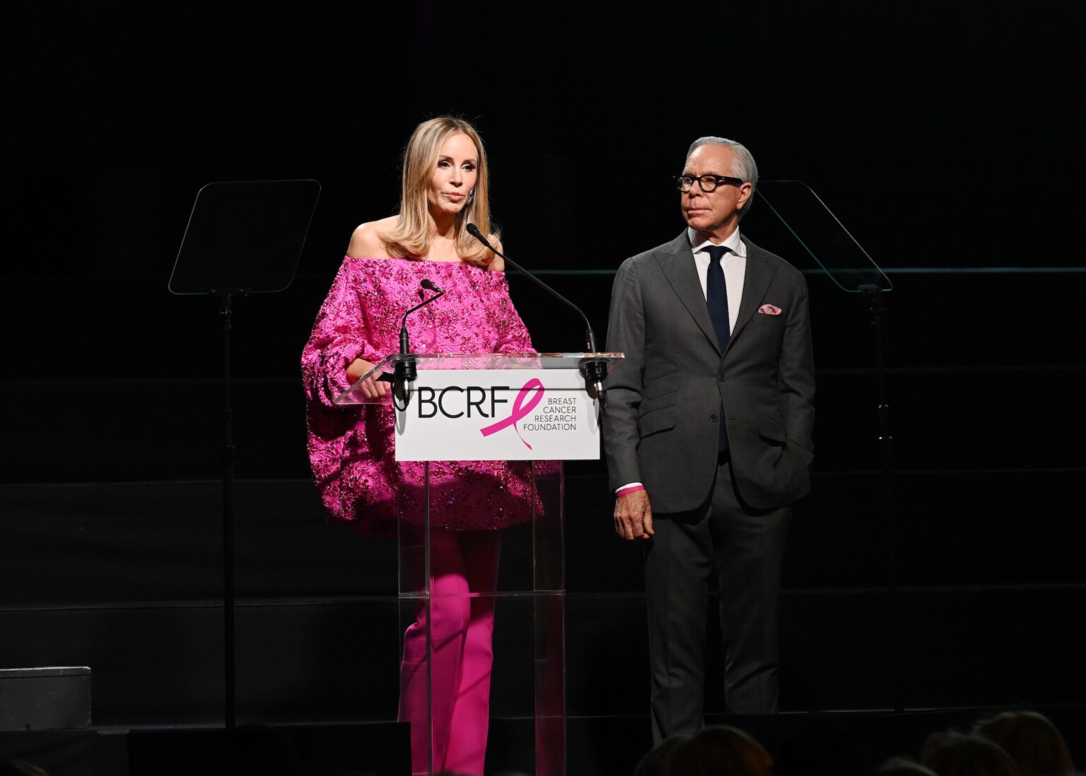 NEW YORK, NEW YORK - OCTOBER 30: (L-R) Dee Ocleppo Hilfiger and Tommy Hilfiger speak onstage at the Breast Cancer Research Foundation New York Symposium & Awards Luncheon at New York Hilton Midtown on October 30, 2025 in New York City. (Photo by Bryan Bedder/Getty Images for Breast Cancer Research Foundation)