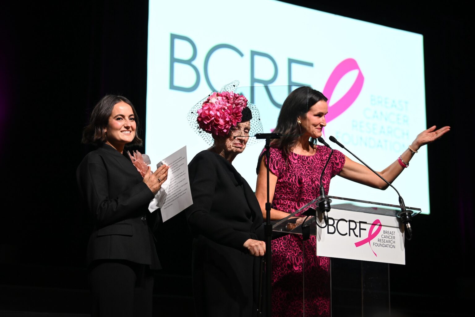 NEW YORK, NEW YORK - OCTOBER 30: (L-R) Eliana Lauder, Roslyn Goldstein and Lydia Fenet speak onstage at the Breast Cancer Research Foundation New York Symposium & Awards Luncheon at New York Hilton Midtown on October 30, 2025 in New York City. (Photo by Bryan Bedder/Getty Images for Breast Cancer Research Foundation)