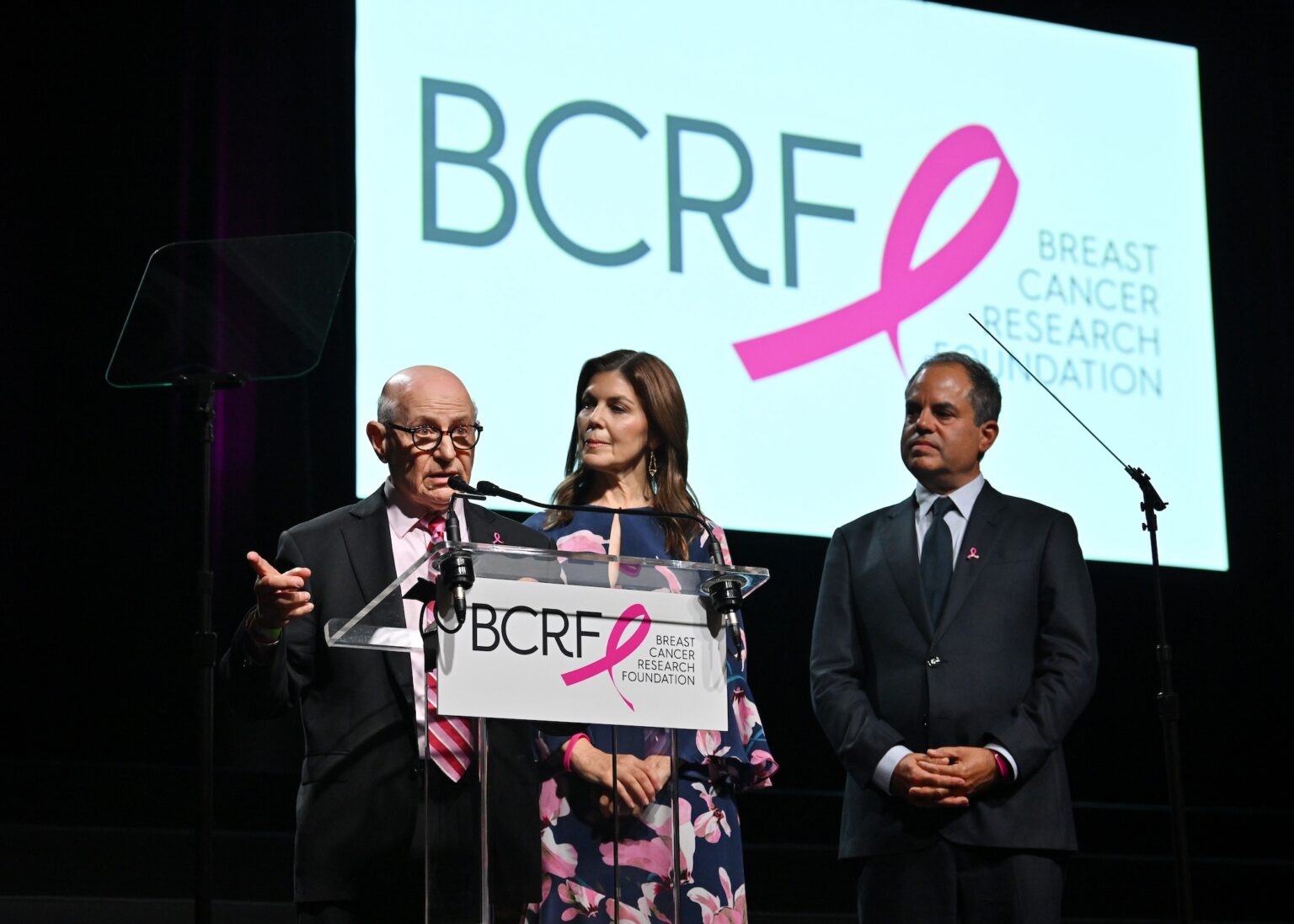 NEW YORK, NEW YORK - OCTOBER 30: (L-R) Dr. Larry Norton, Wendy Rose and Andy Rose speak onstage at the Breast Cancer Research Foundation New York Symposium & Awards Luncheon at New York Hilton Midtown on October 30, 2025 in New York City. (Photo by Bryan Bedder/Getty Images for Breast Cancer Research Foundation)