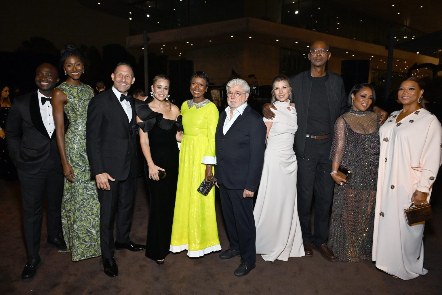 LOS ANGELES, CALIFORNIA - NOVEMBER 01: (L-R) Wemimo Abbey, Taylor Abbey, guest, guest, Mellody Hobson, George Lucas, Stephanie Bongiovi, Mark Bradford, Eboni Nichols and Queen Latifah attend the 2025 LACMA Art+Film Gala, Presented By Gucci at Los Angeles County Museum of Art on November 01, 2025 in Los Angeles, California. (Photo by Michael Kovac/Getty Images for LACMA)